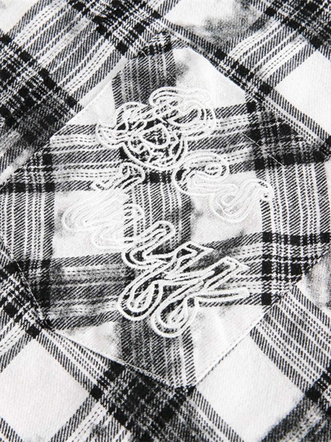 Intricate stitching details on TALISHKO's distressed plaid lace short-sleeve shirt pattern.