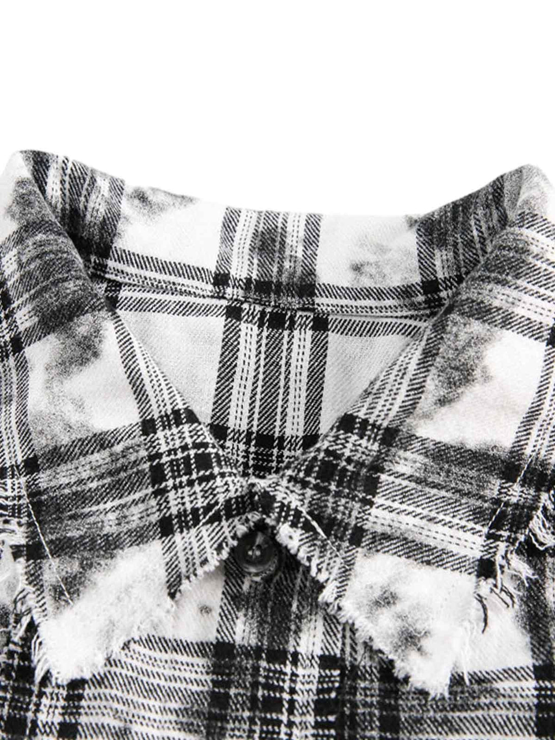 A close-up of TALISHKO's distressed plaid lace shirt, highlighting its detailed texture.