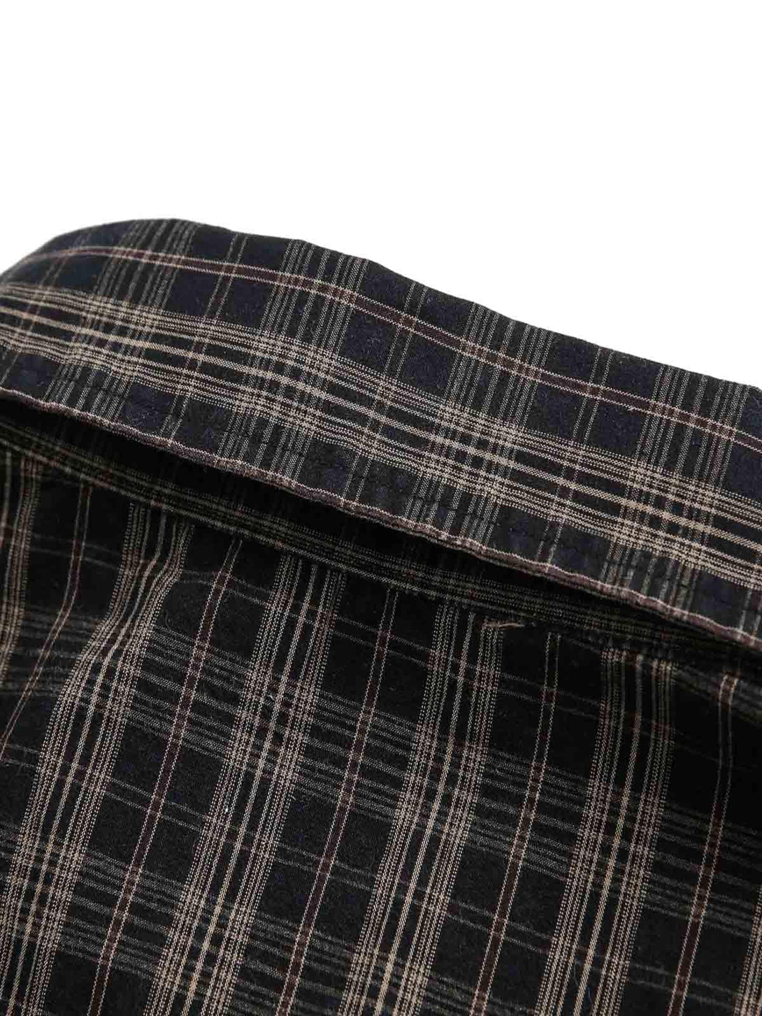 Detailed fabric and stitching on a distressed plaid short-sleeve shirt by TALISHKO.