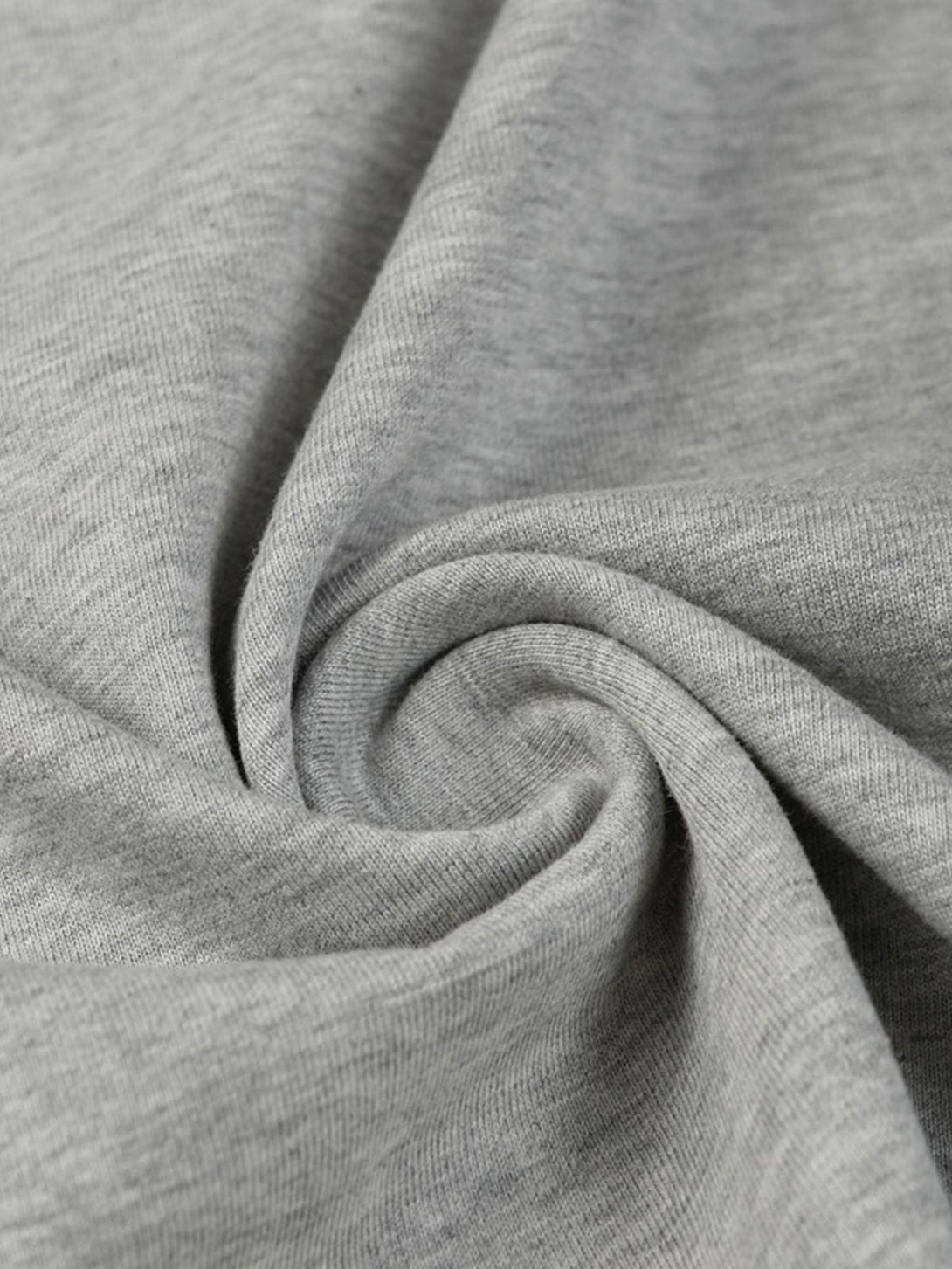 Zoomed-in texture of TALISHKO's gray T-shirt fabric, highlighting its soft material.