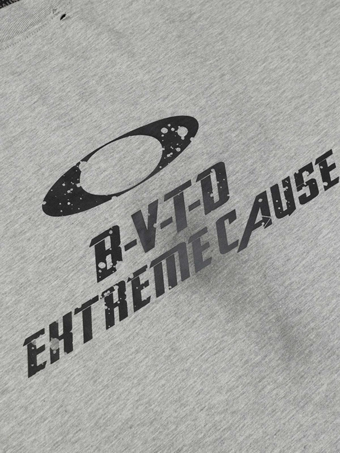 A close-up of TALISHKO's gray distressed T-shirt, featuring bold graphic text and unique design.