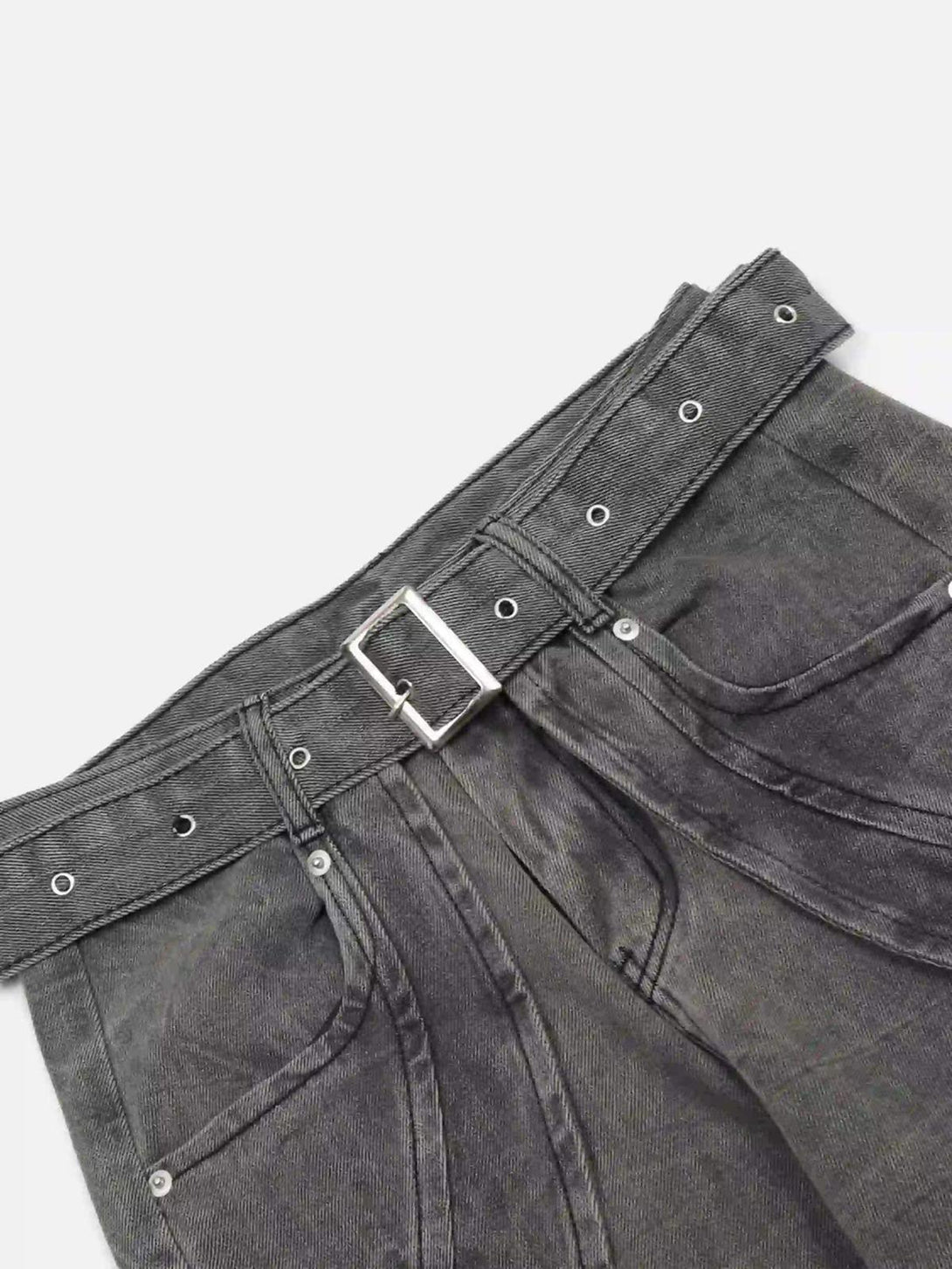 Intricate look at TALISHKO's distressed punk jeans, highlighting the metal belt and fabric texture.