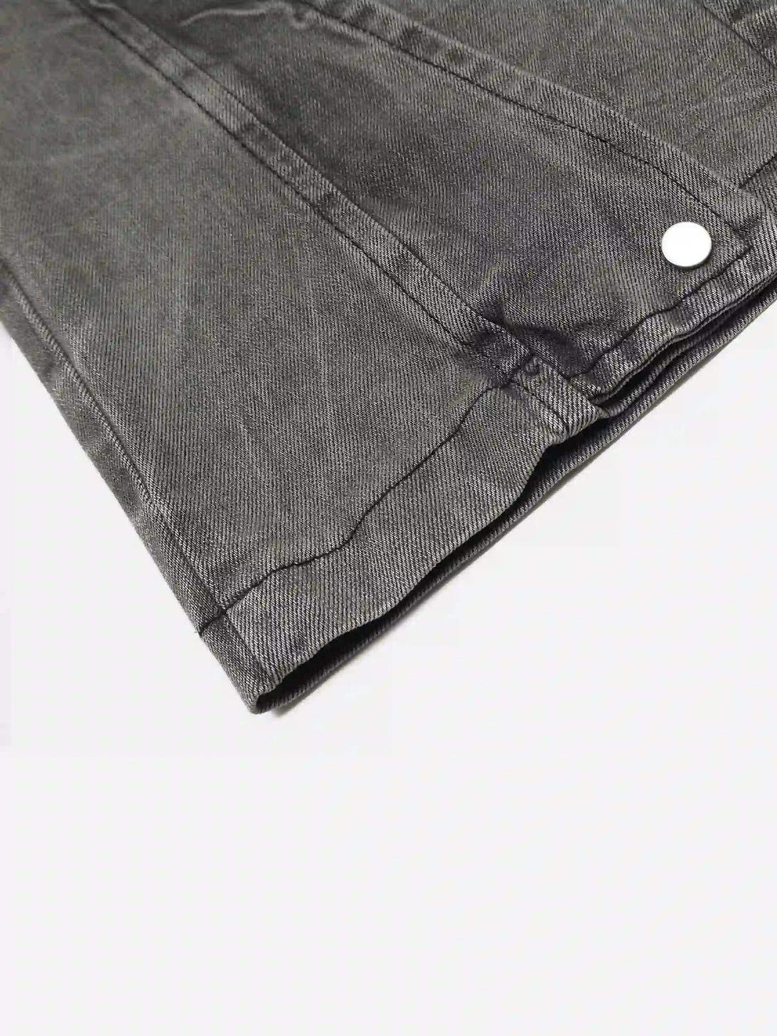 A detailed view of TALISHKO's distressed punk jeans, emphasizing the fabric texture and seams.