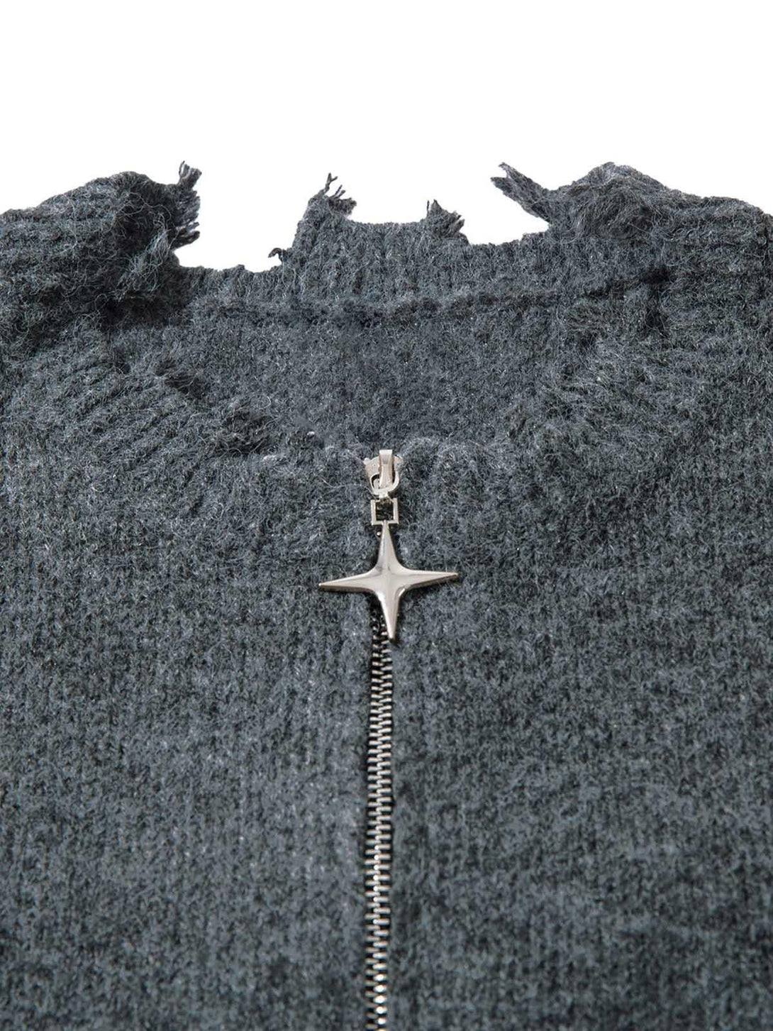 Focusing on the frayed neckline and zipper detail of a distressed sweater by TALISHKO.