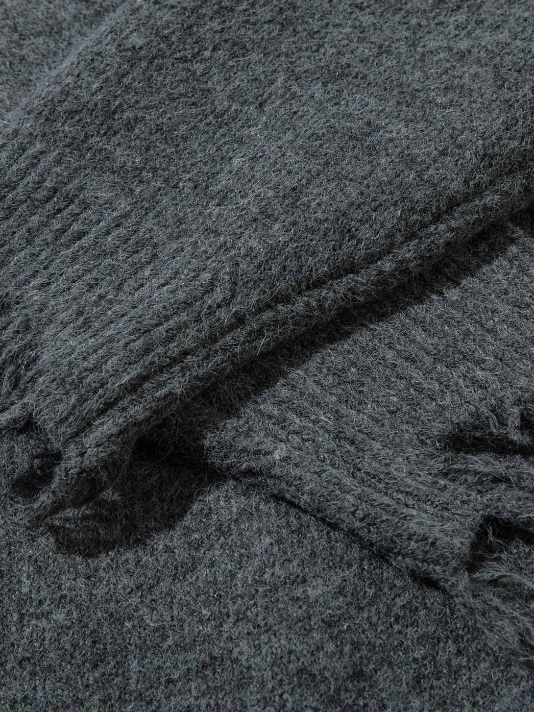 A detailed view of the textured fabric on the distressed sweater by TALISHKO.