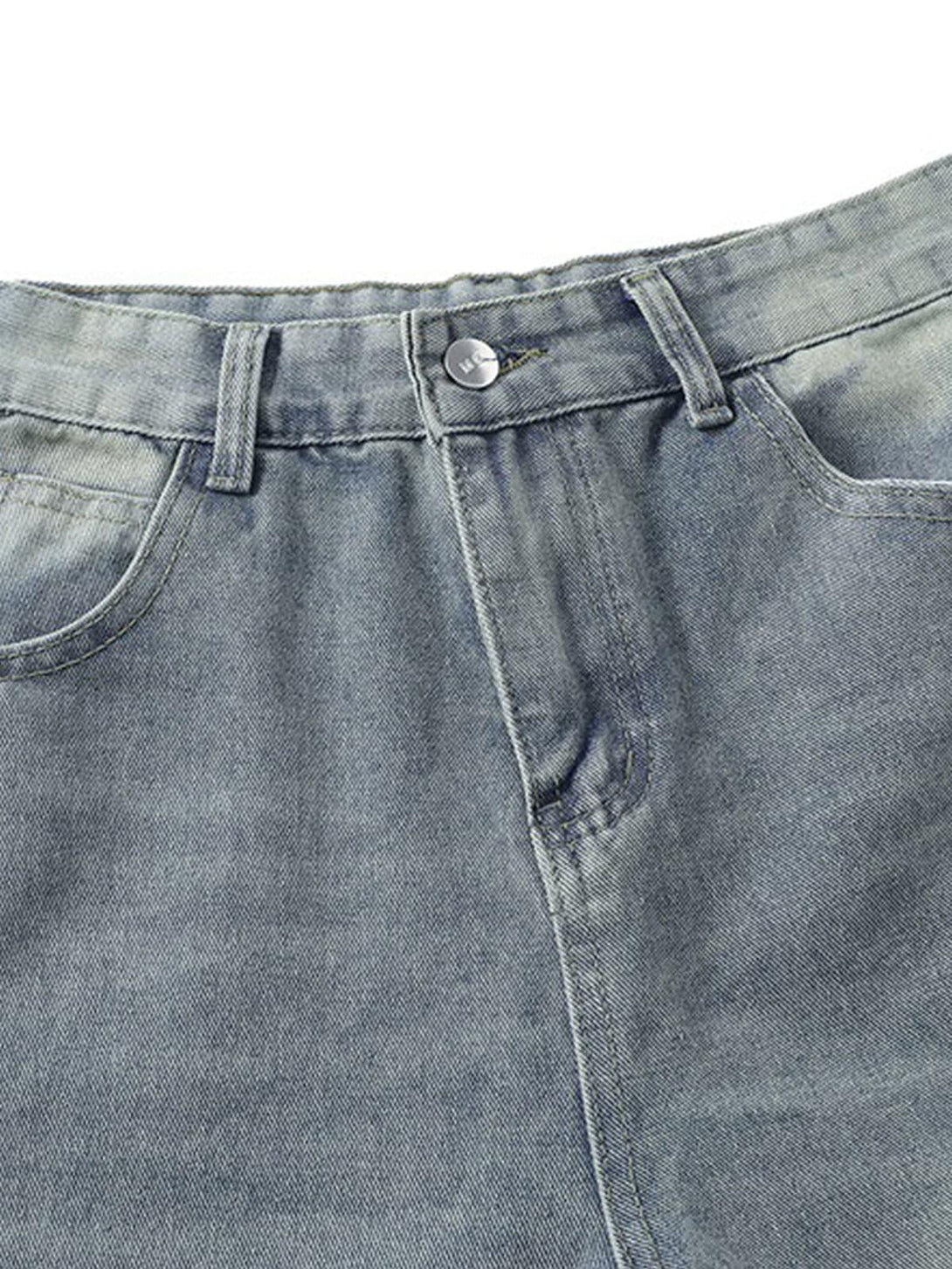 Detailed fabric and stitching on TALISHKO distressed baggy jeans, highlighting raw edge design.