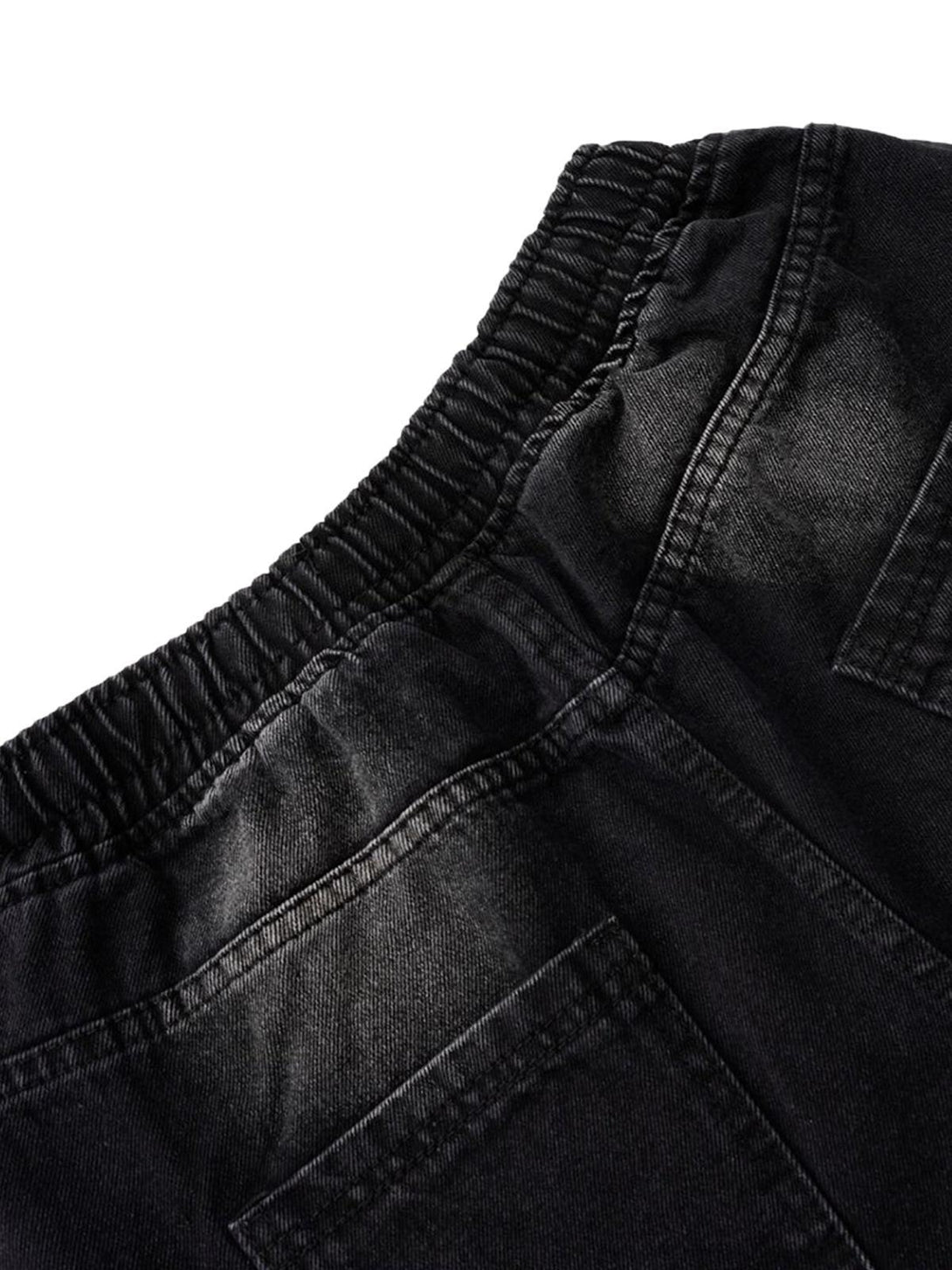 Intricate look at TALISHKO's distressed barrel jeans, highlighting the elastic waistband detail.