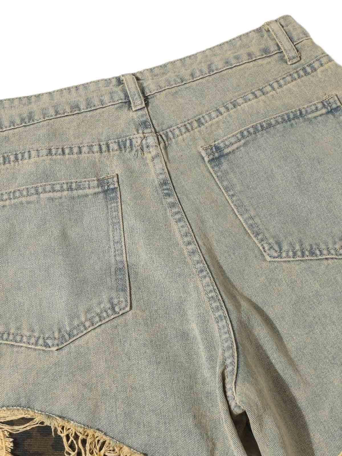 Back view of TALISHKO jeans, highlighting distressed raw edges and textured fabric.