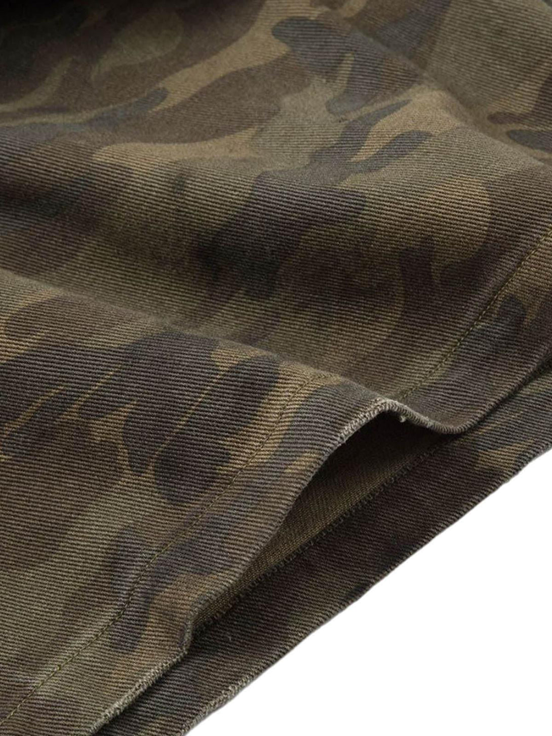A close-up of TALISHKO shorts featuring camo lining and distressed fabric texture.
