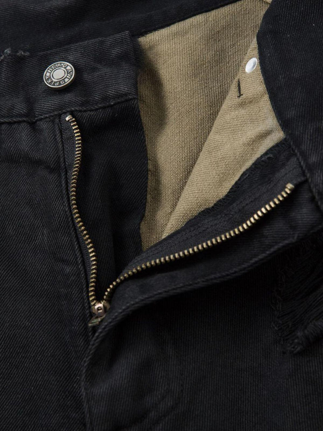 Focusing on the TALISHKO black denim shorts zipper and camo lining for an edgy look.