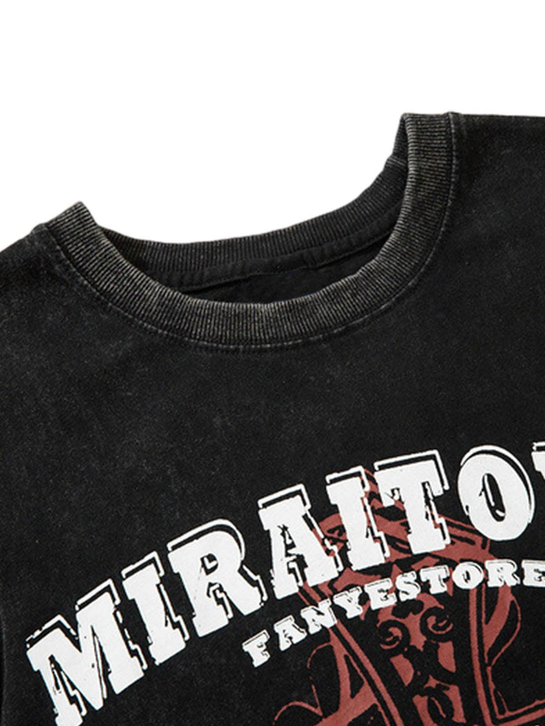 A close-up of a distressed black vest by TALISHKO, featuring bold graphic lettering.