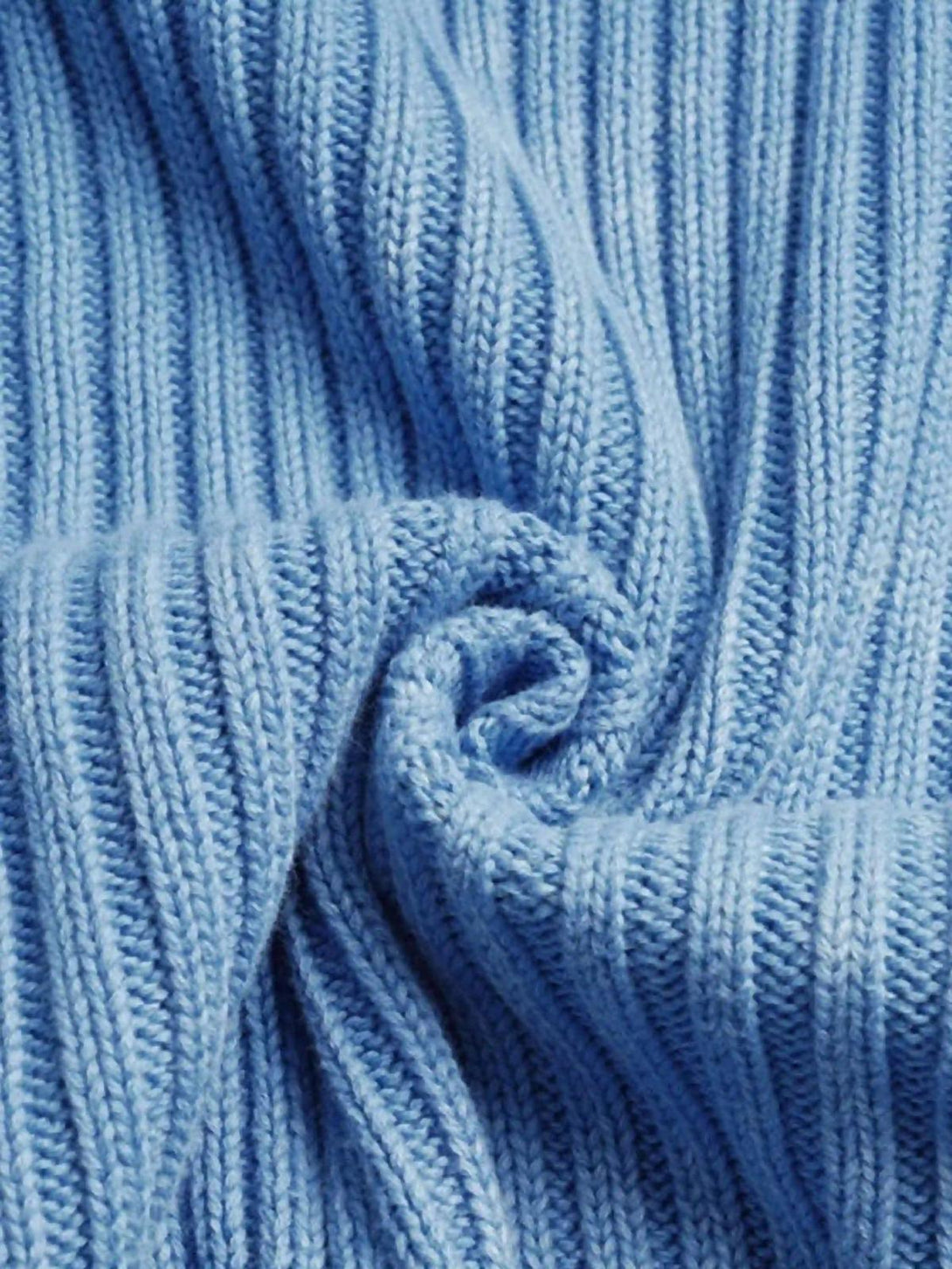 Texture and pattern showcased in a blue sweater knit, highlighting TALISHKO's craftsmanship.
