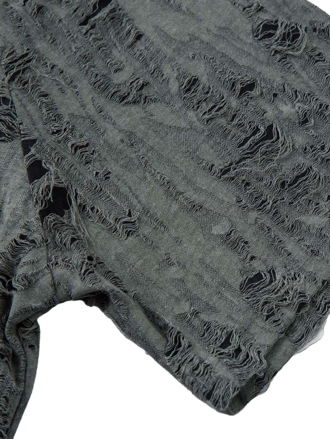 Focusing on the distressed fabric of a TALISHKO short sleeve shirt, showcasing unique texture.