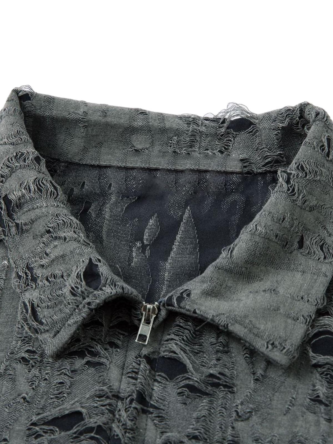 Zoomed-in texture of a distressed short sleeve shirt by TALISHKO, highlighting its unique details.