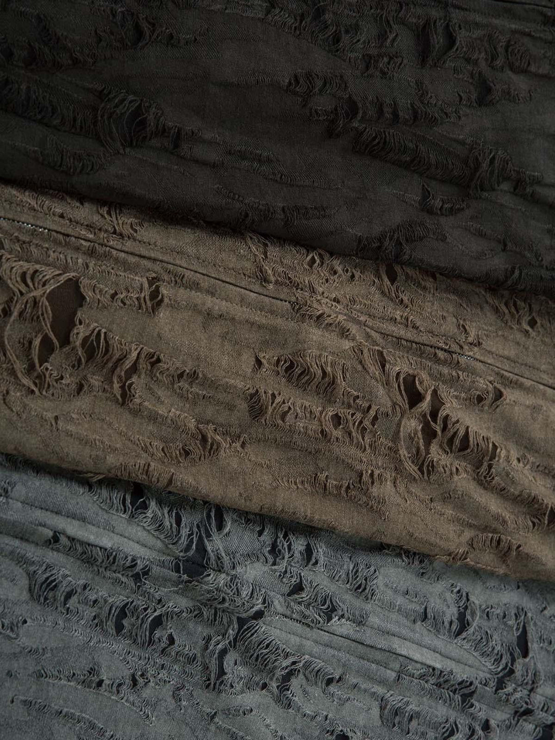 A detailed view of the distressed texture on a TALISHKO short sleeve shirt, highlighting its unique design.
