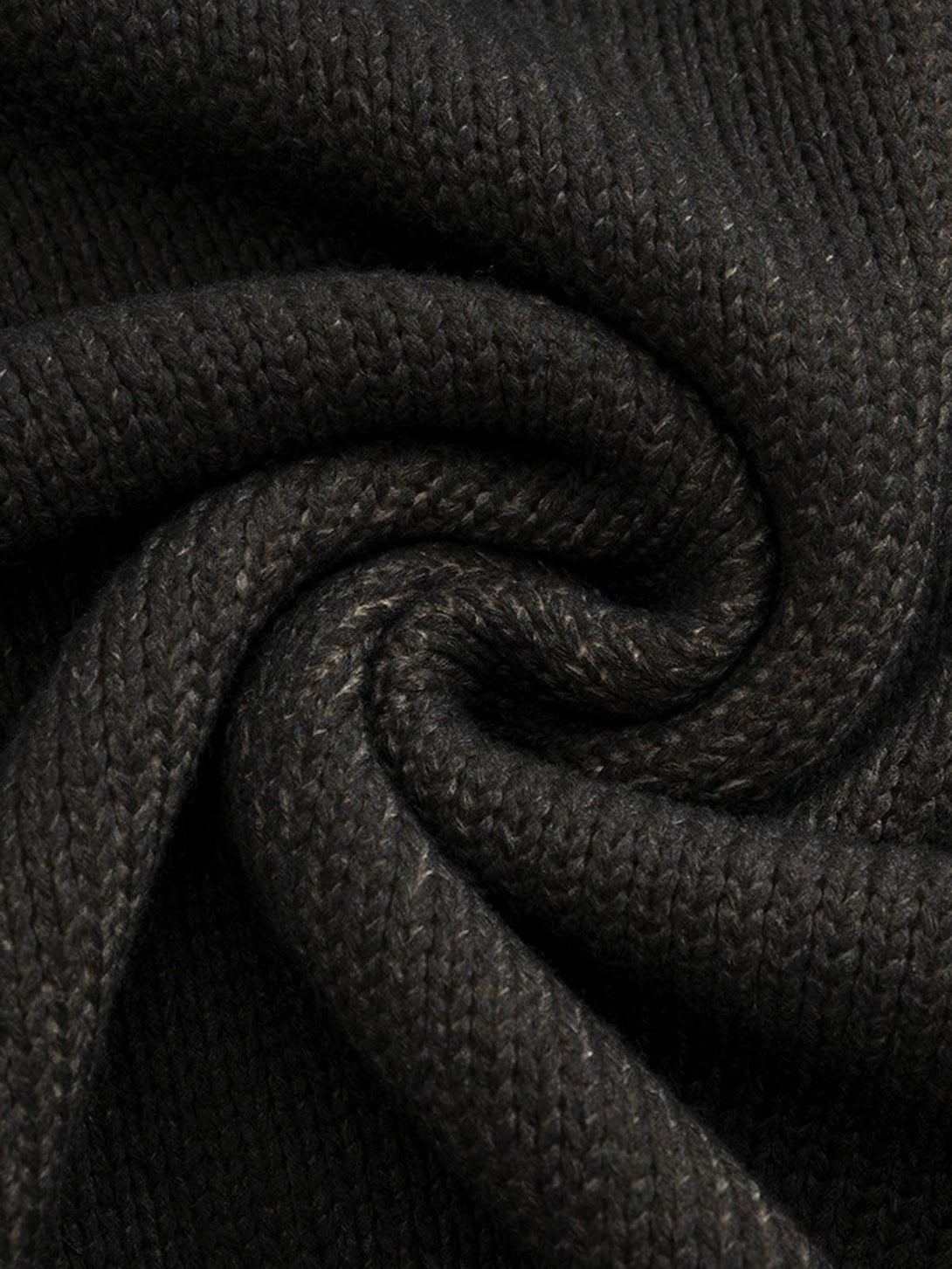 Intricate look at the black knit texture of a distressed pullover sweater by TALISHKO.