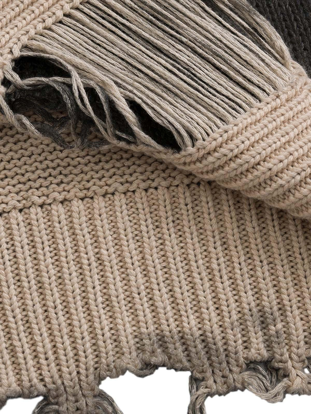 Detailed fabric and stitching of a distressed oversized pullover sweater by TALISHKO.