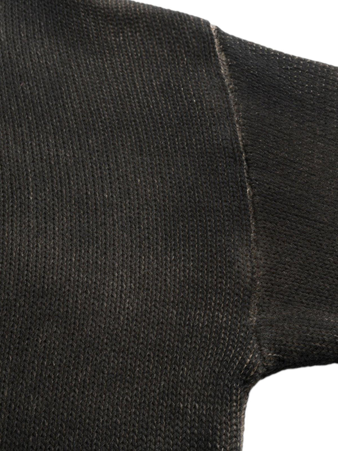 Zoomed-in texture of a distressed oversized pullover sweater by TALISHKO, showcasing knit details.