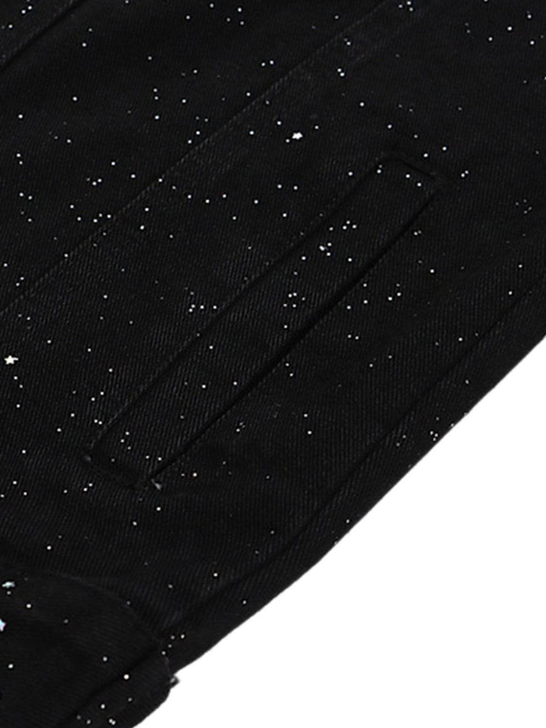 Zoomed-in texture of TALISHKO's denim jacket, featuring a starry sequin pattern.