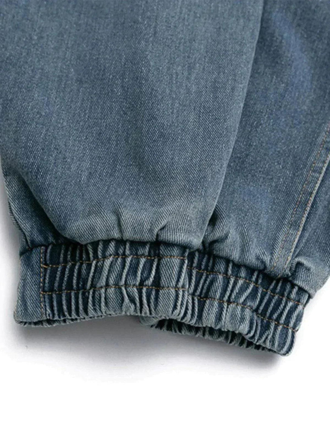 Focusing on the cuff detail of the TALISHKO denim jacket, highlighting its durable stitching.