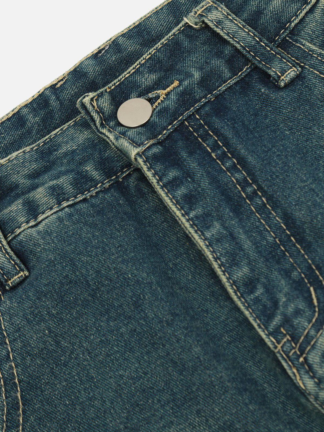 A detailed view of TALISHKO jeans highlighting the button and stitching details.