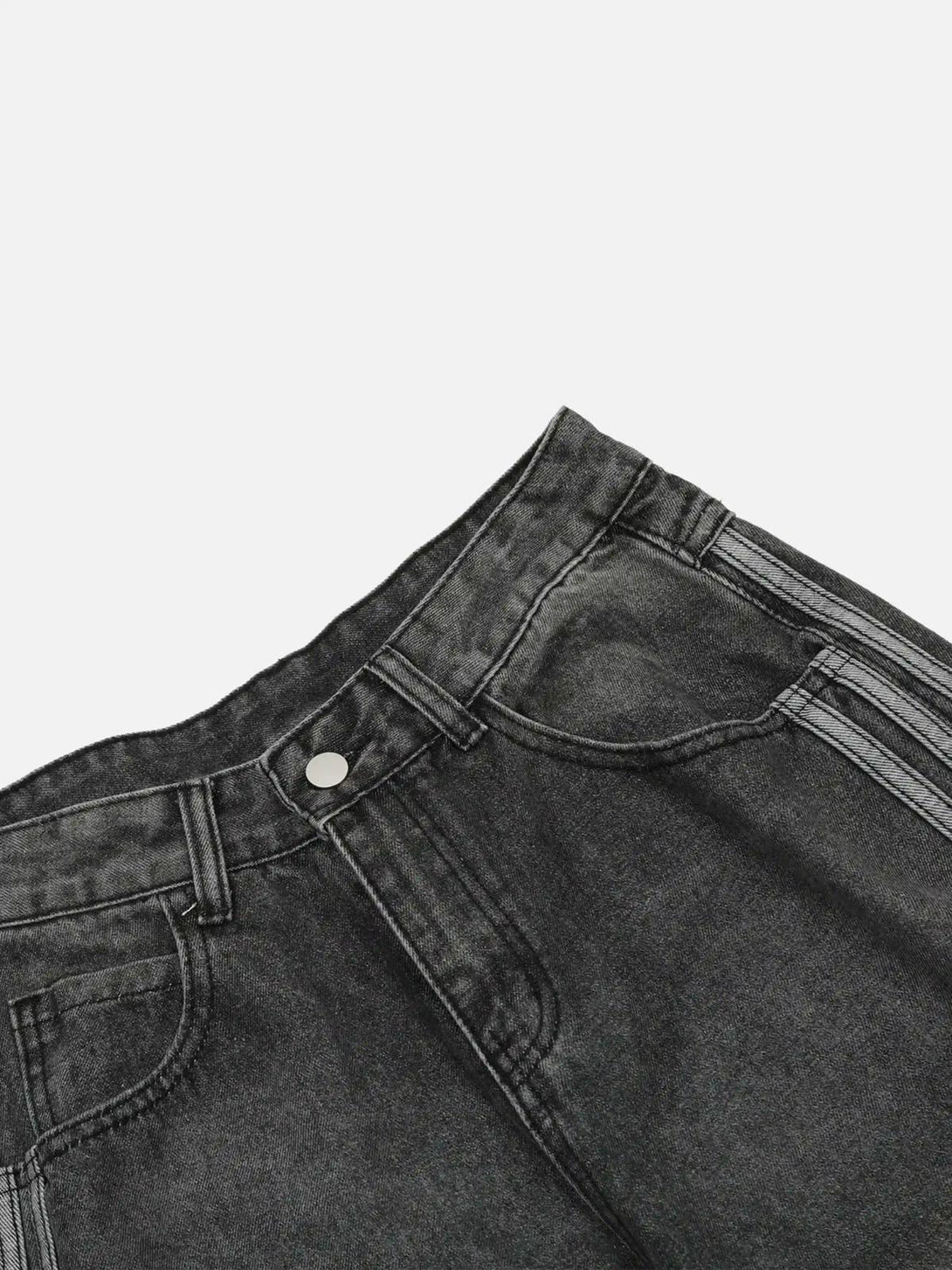 Detailed view of TALISHKO distressed jeans, highlighting the dark denim texture and stitching.