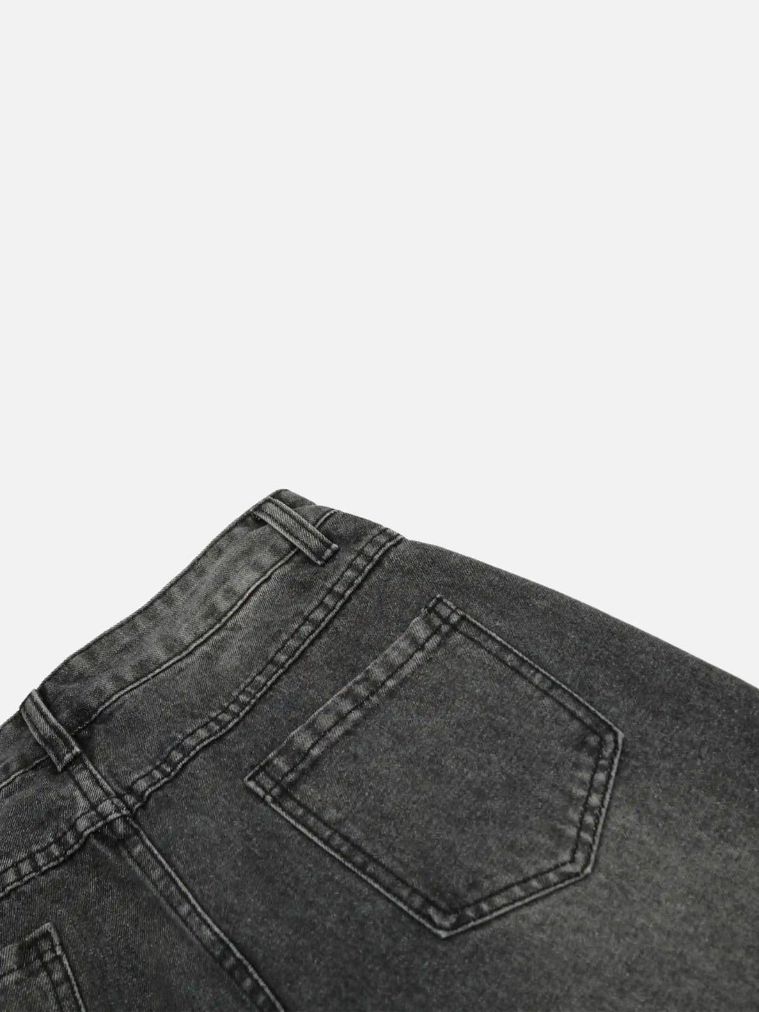 Detailed fabric and stitching of TALISHKO distressed jeans, showcasing back pocket design.