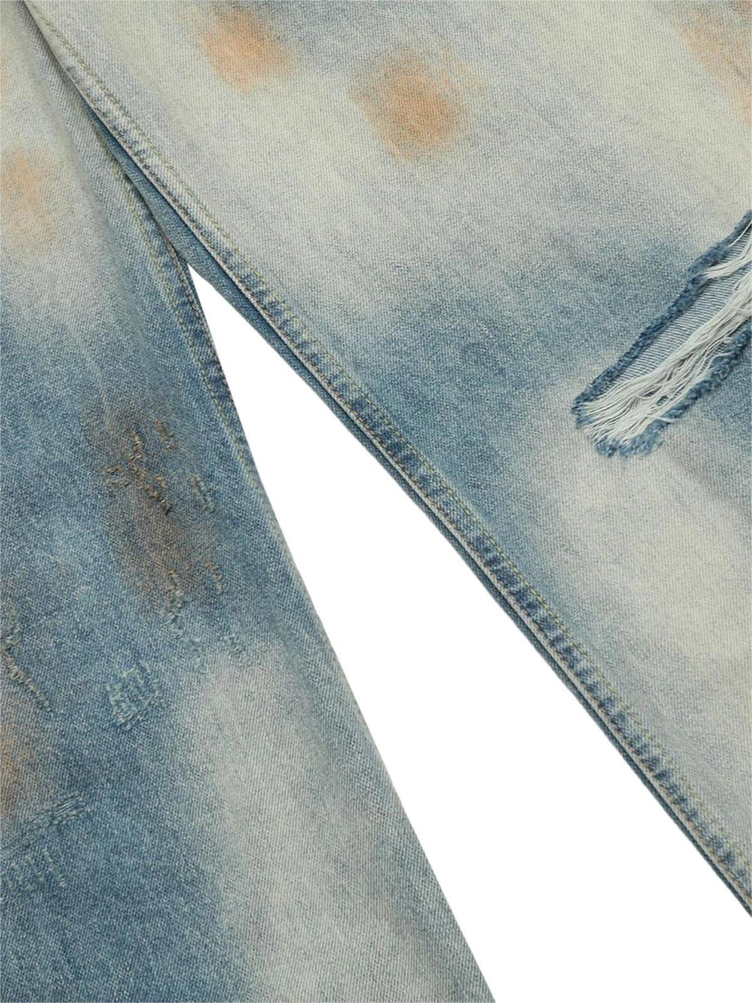 Focusing on the distressed fabric and texture of TALISHKO street hip-hop jeans in blue.