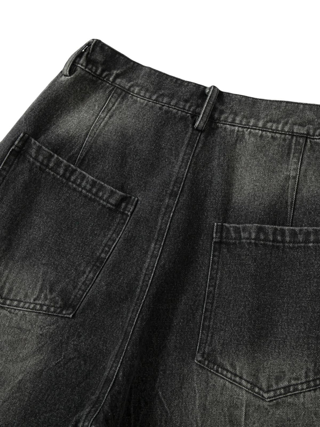 Back view of TALISHKO jeans highlighting patch pockets and distressed black denim texture.