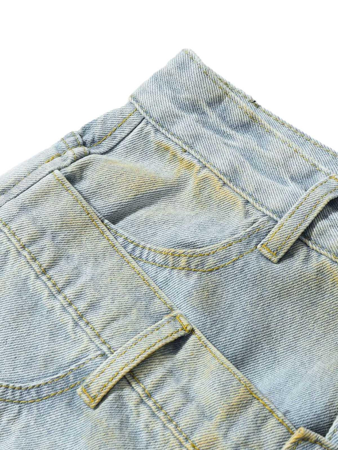 Detailed fabric and stitching on TALISHKO's distressed tie-dye denim shorts, highlighting rugged design.