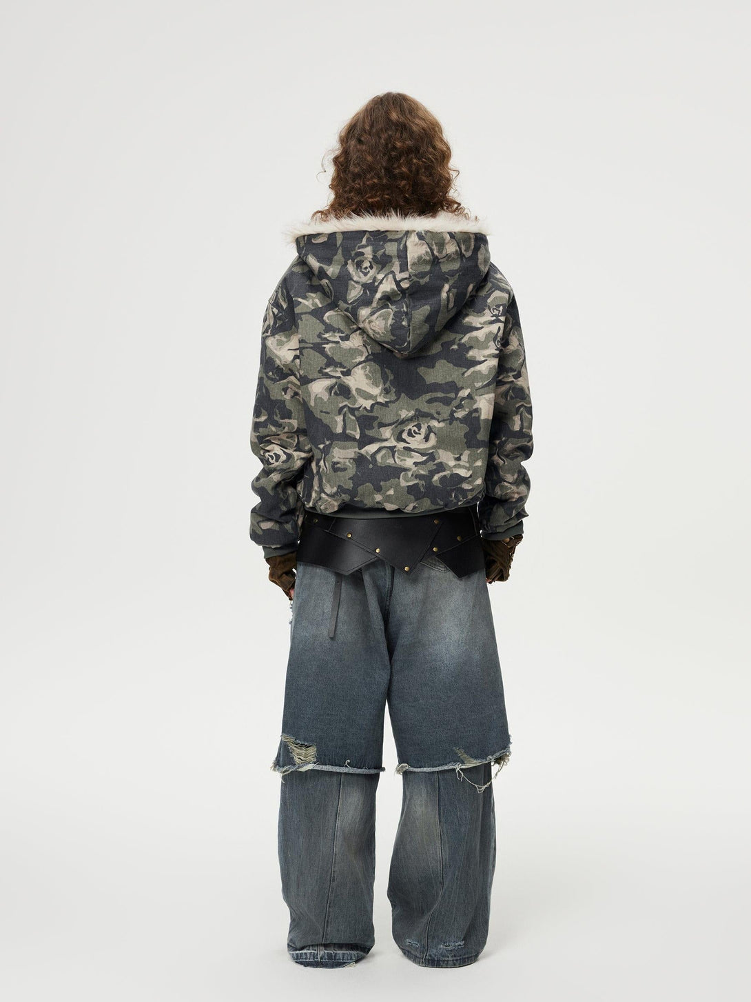 Back view of TALISHKO floral camo jacket paired with distressed baggy jeans, embodying urban style.