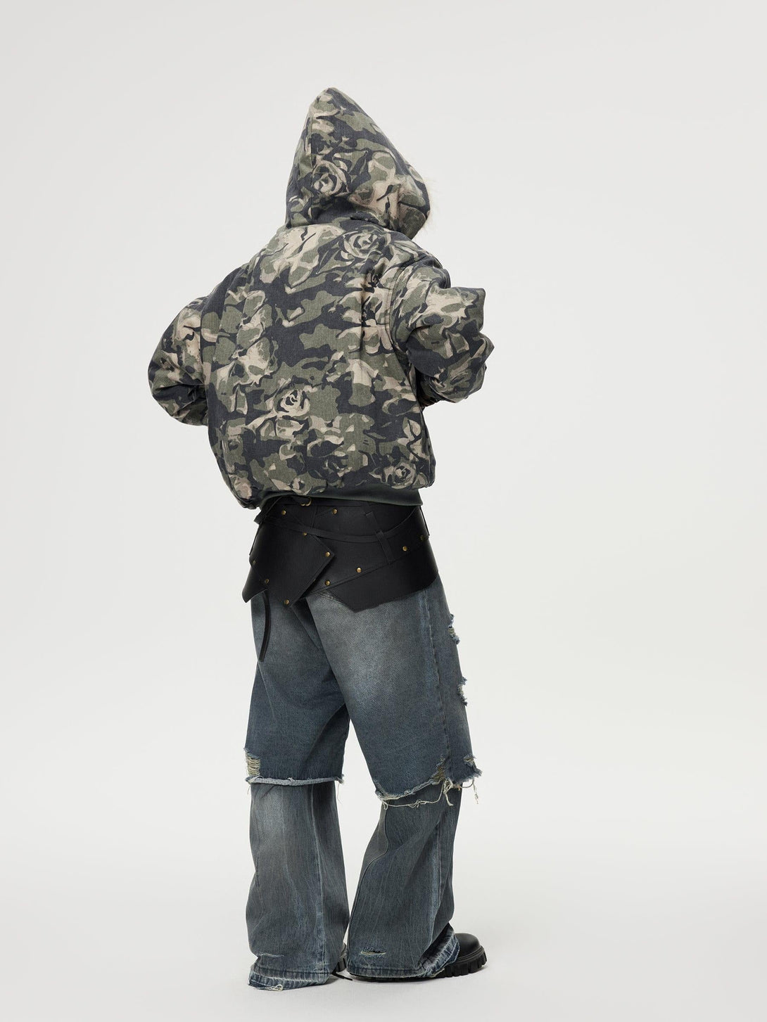 Back view of TALISHKO floral camo jacket and distressed jeans, highlighting edgy streetwear.