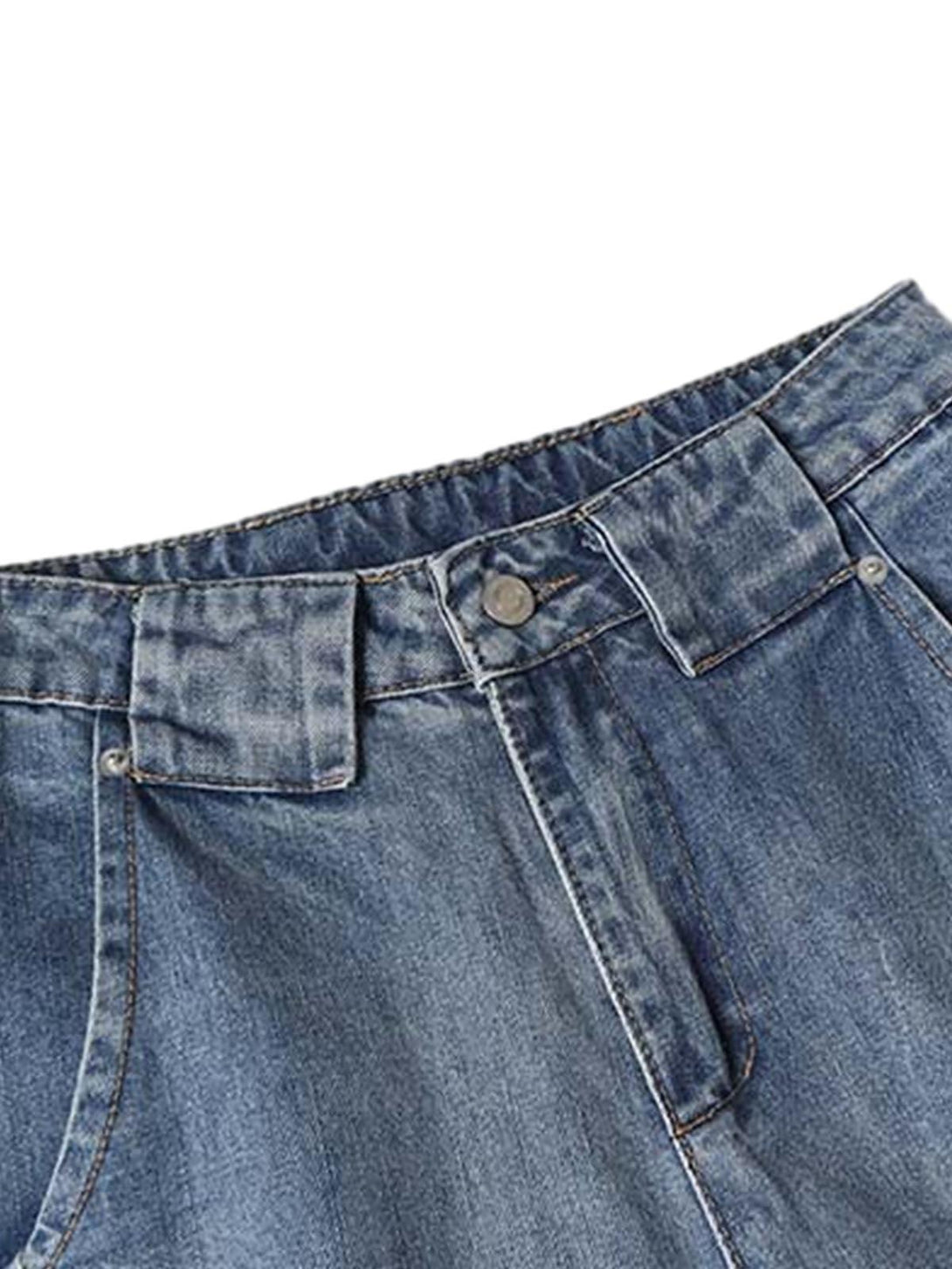 A close-up of TALISHKO's distressed barrel jeans, highlighting the elastic waistband and button detail.