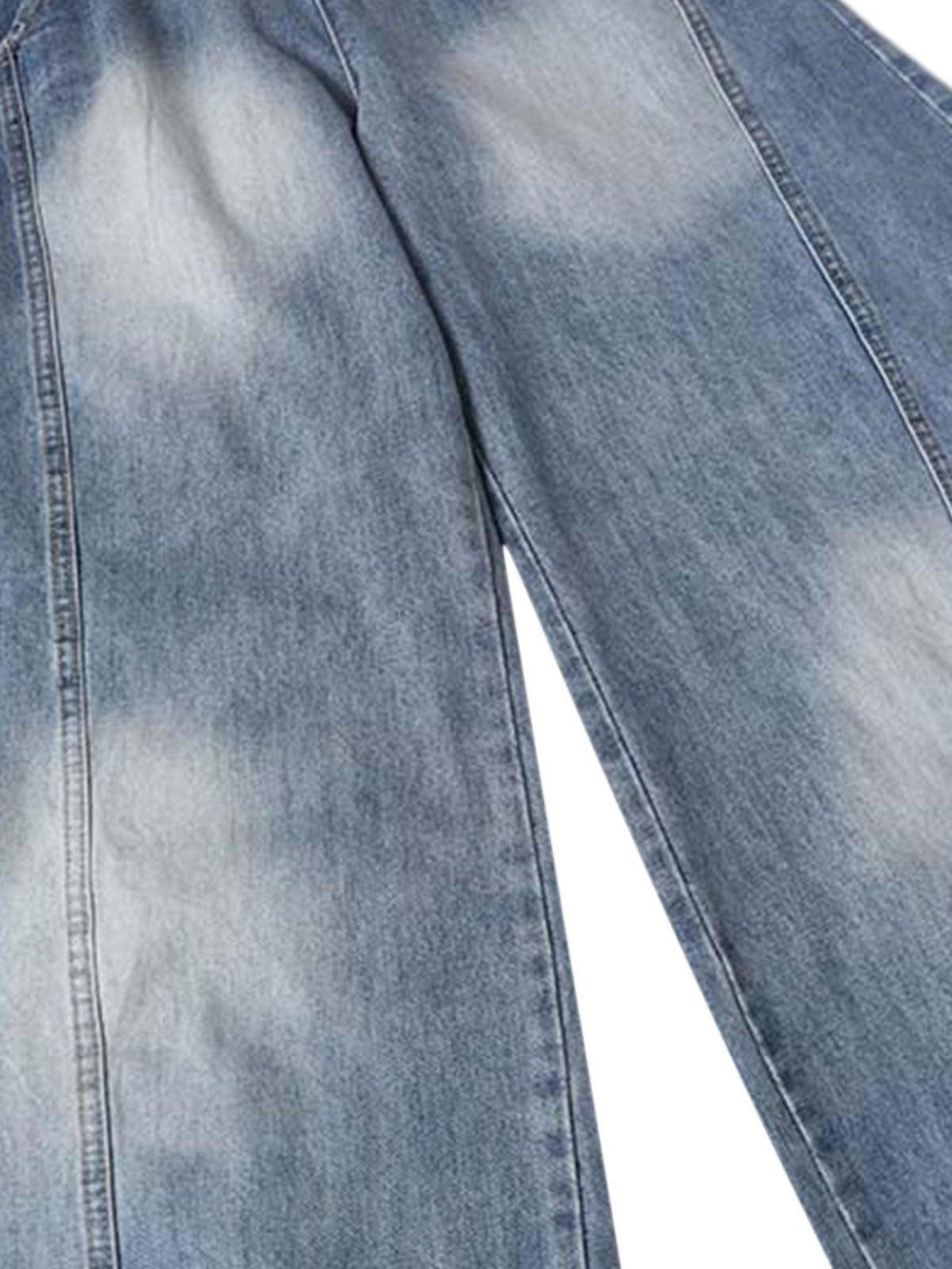 A close-up of TALISHKO's distressed denim, showcasing unique wash patterns and texture.
