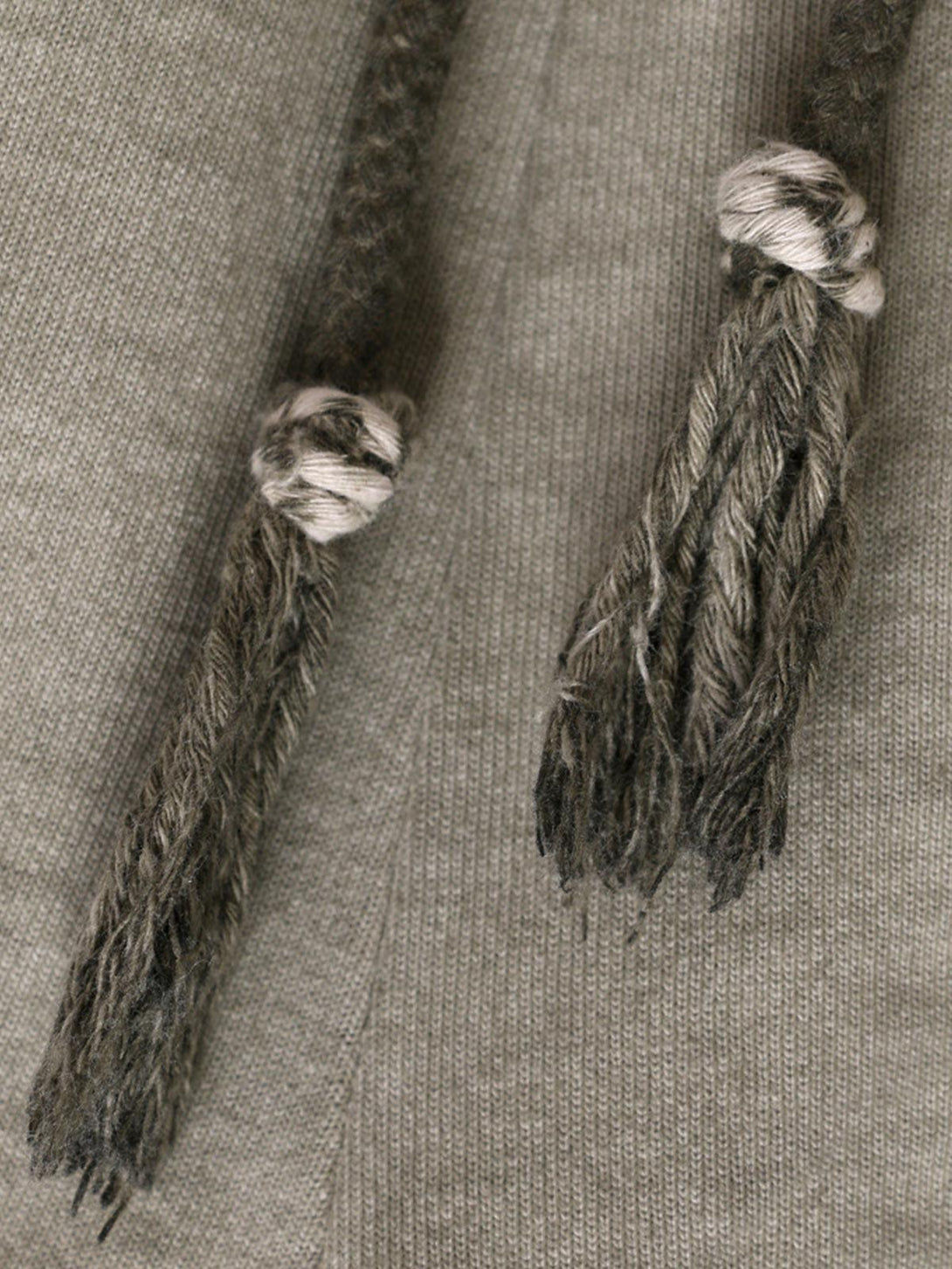 Detailed view of TALISHKO drawstring shorts, focusing on the knotted, distressed fabric texture.
