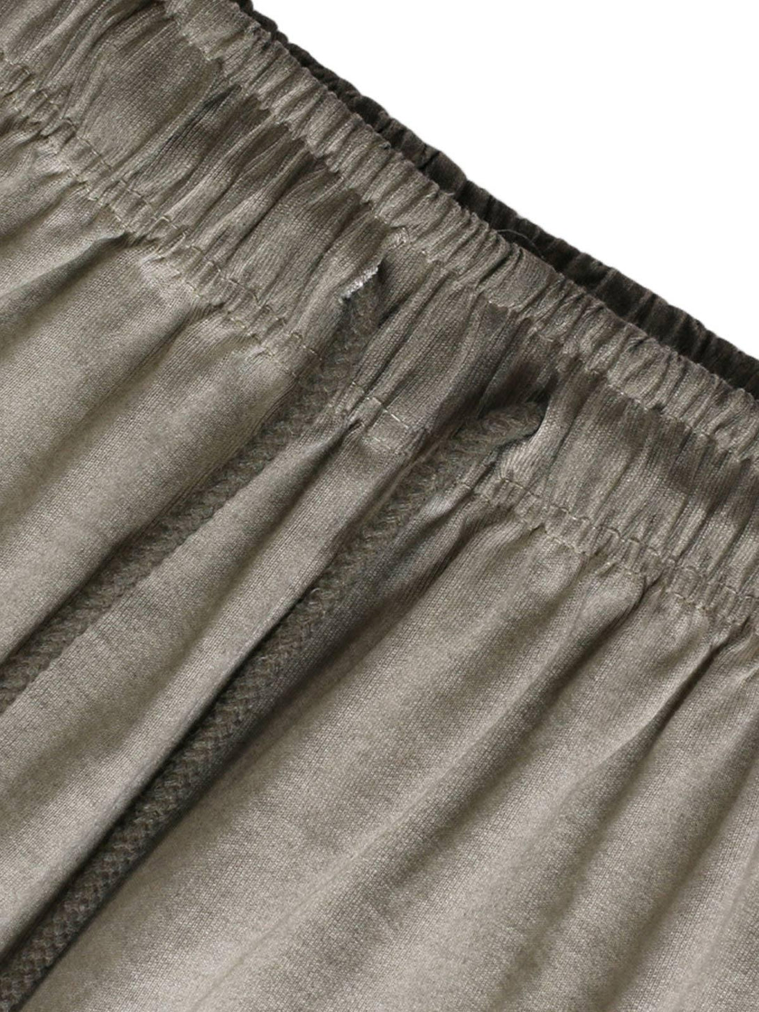 Detailed fabric and stitching of TALISHKO drawstring shorts, showcasing a relaxed, washed texture.