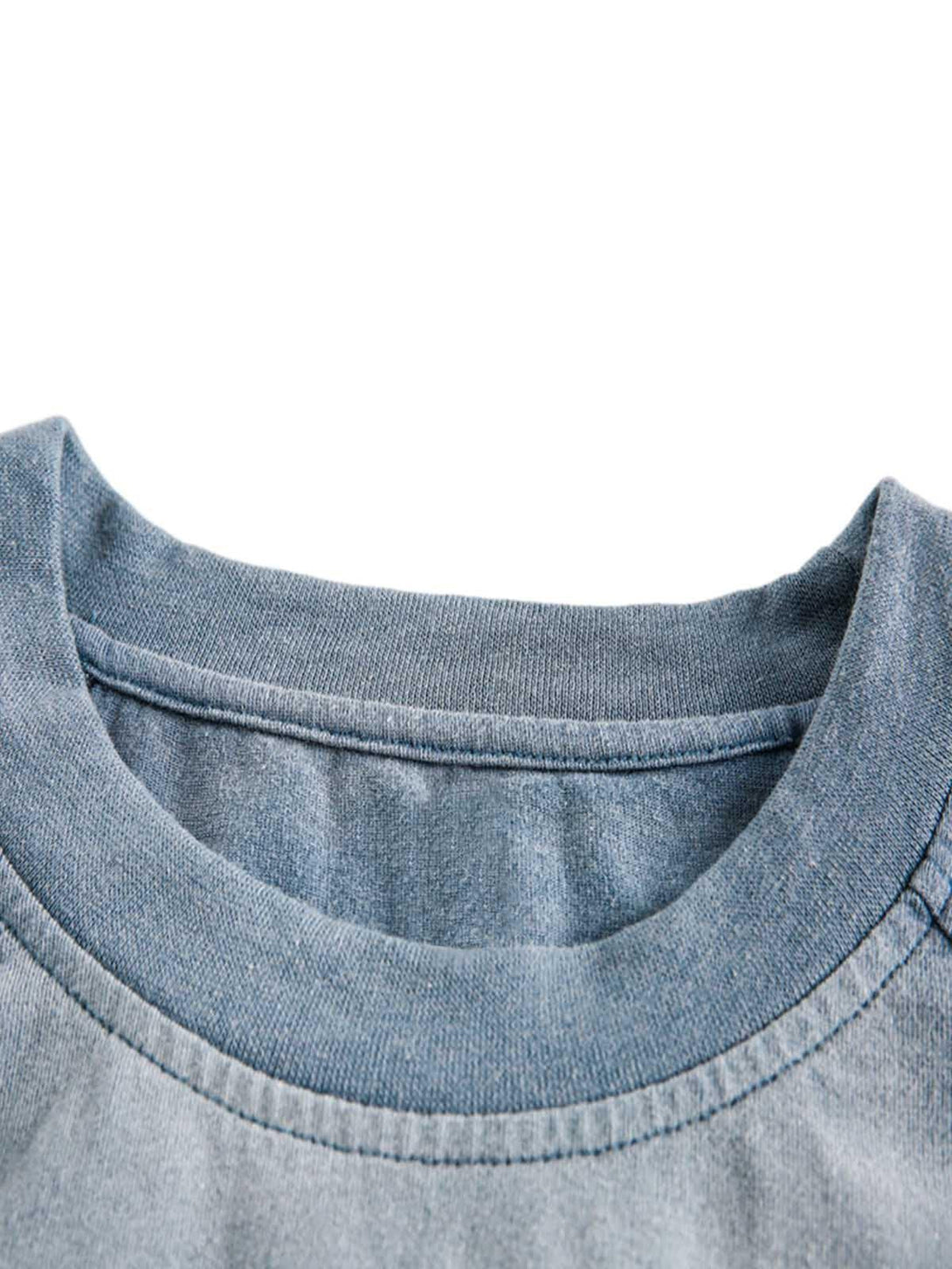 A close-up of TALISHKO's blue distressed washed vest neckline, highlighting its soft texture.