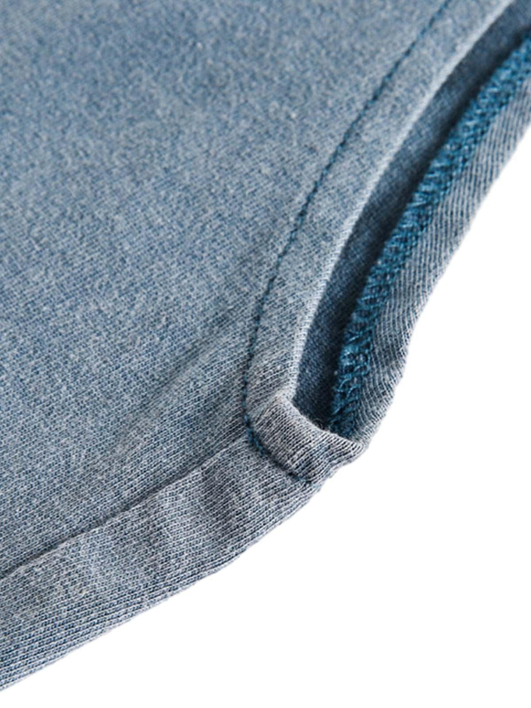 A detailed view of TALISHKO's gradient vest fabric, showcasing its distressed texture and stitching.