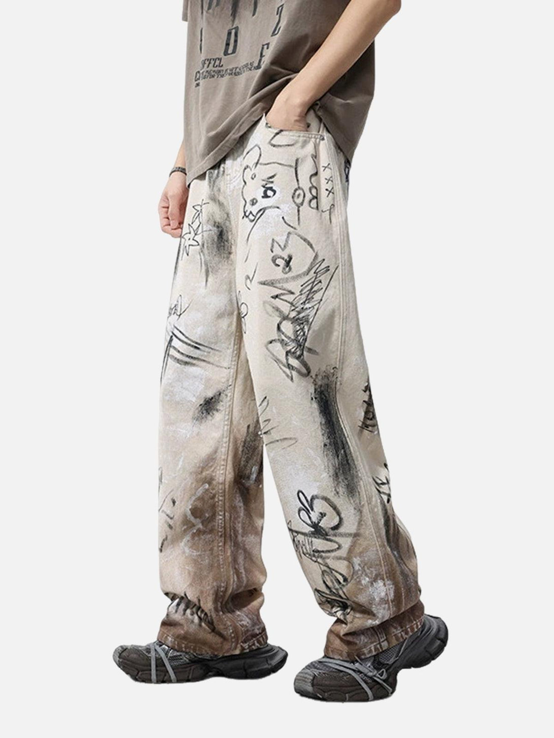 Model wearing TALISHKO distressed baggy jeans with graffiti art, highlighting urban casual style.