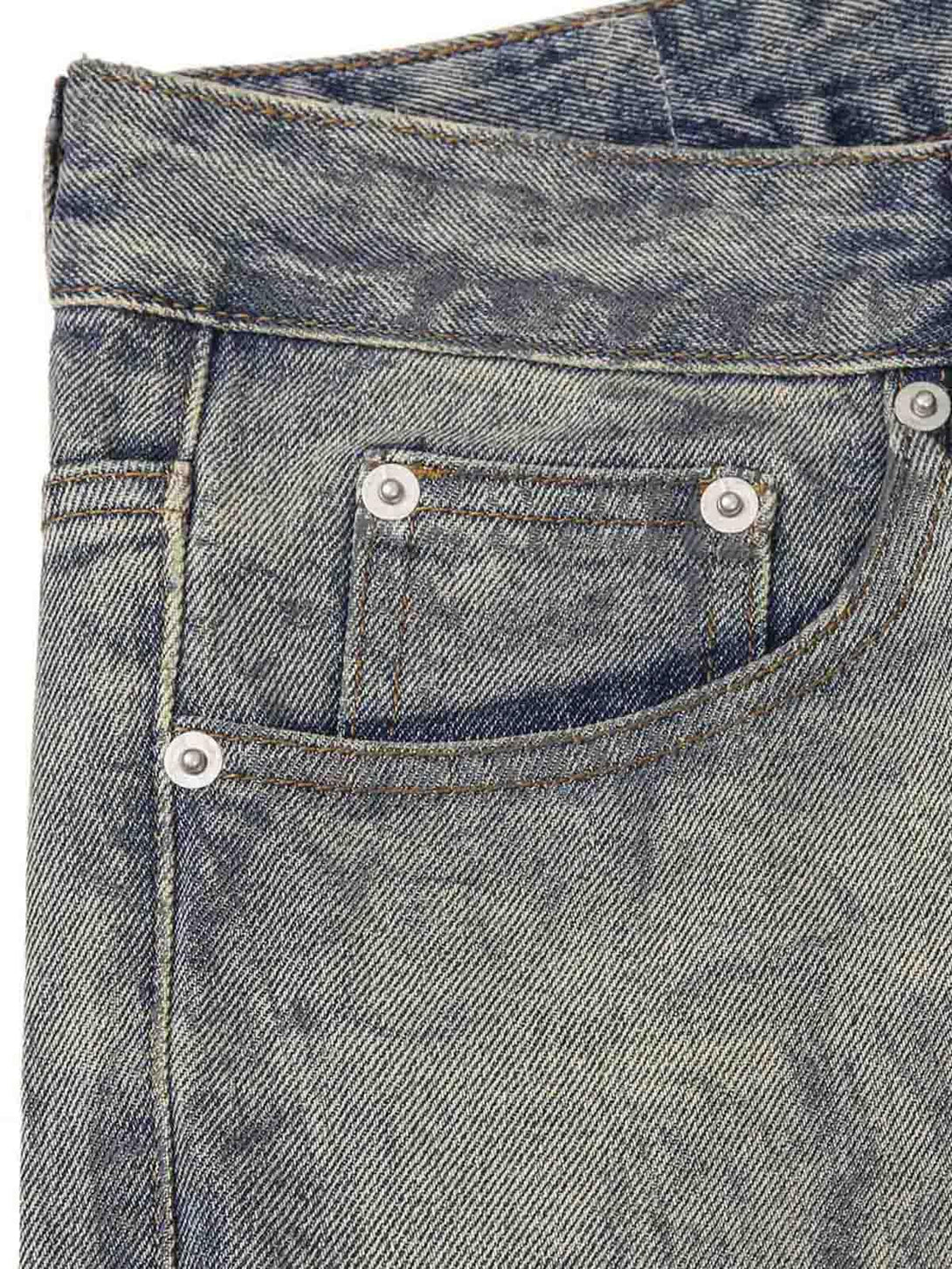 A detailed view of TALISHKO jeans pocket, highlighting the unique washed ink-splashed texture.