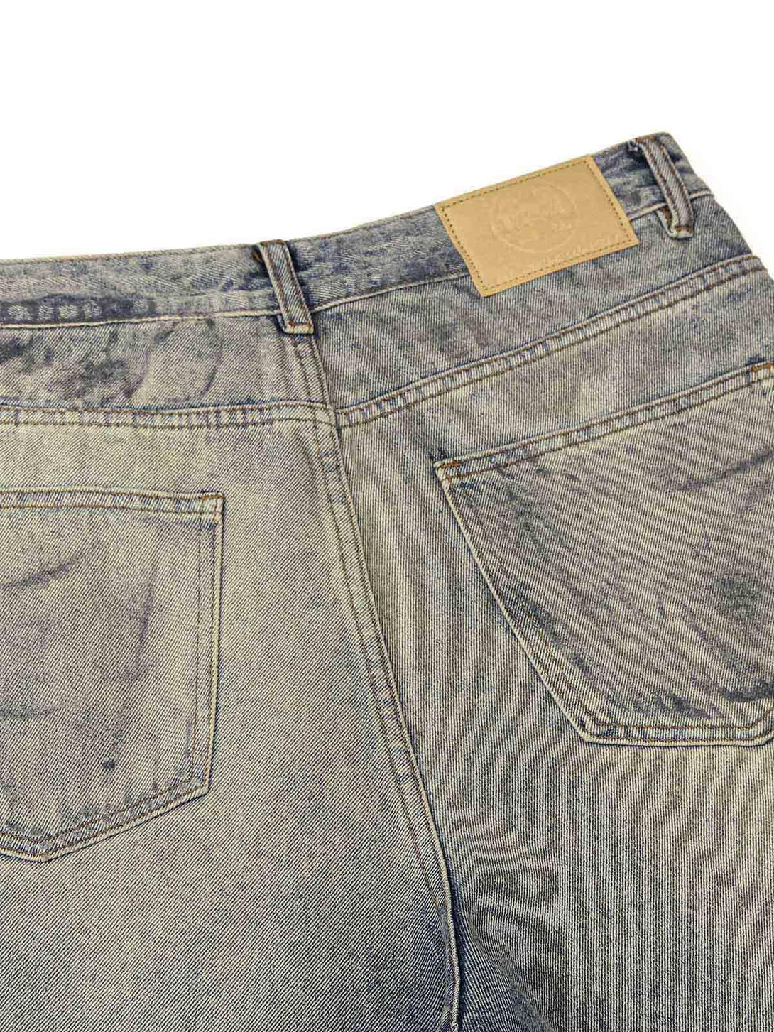 Back view of TALISHKO jeans, highlighting the distressed washed ink-splashed texture.