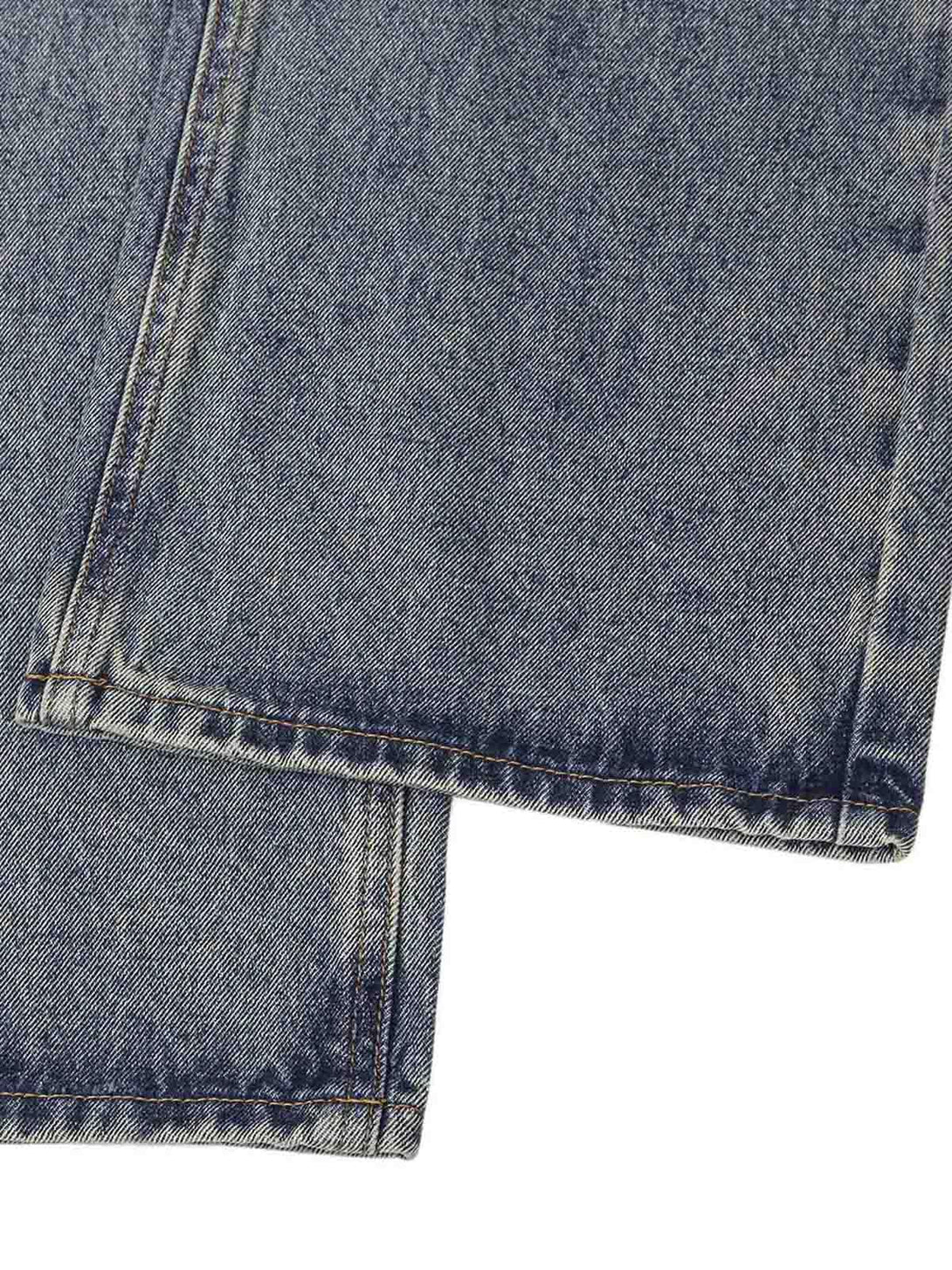 Detailed fabric and stitching of TALISHKO jeans with a washed ink-splashed design.