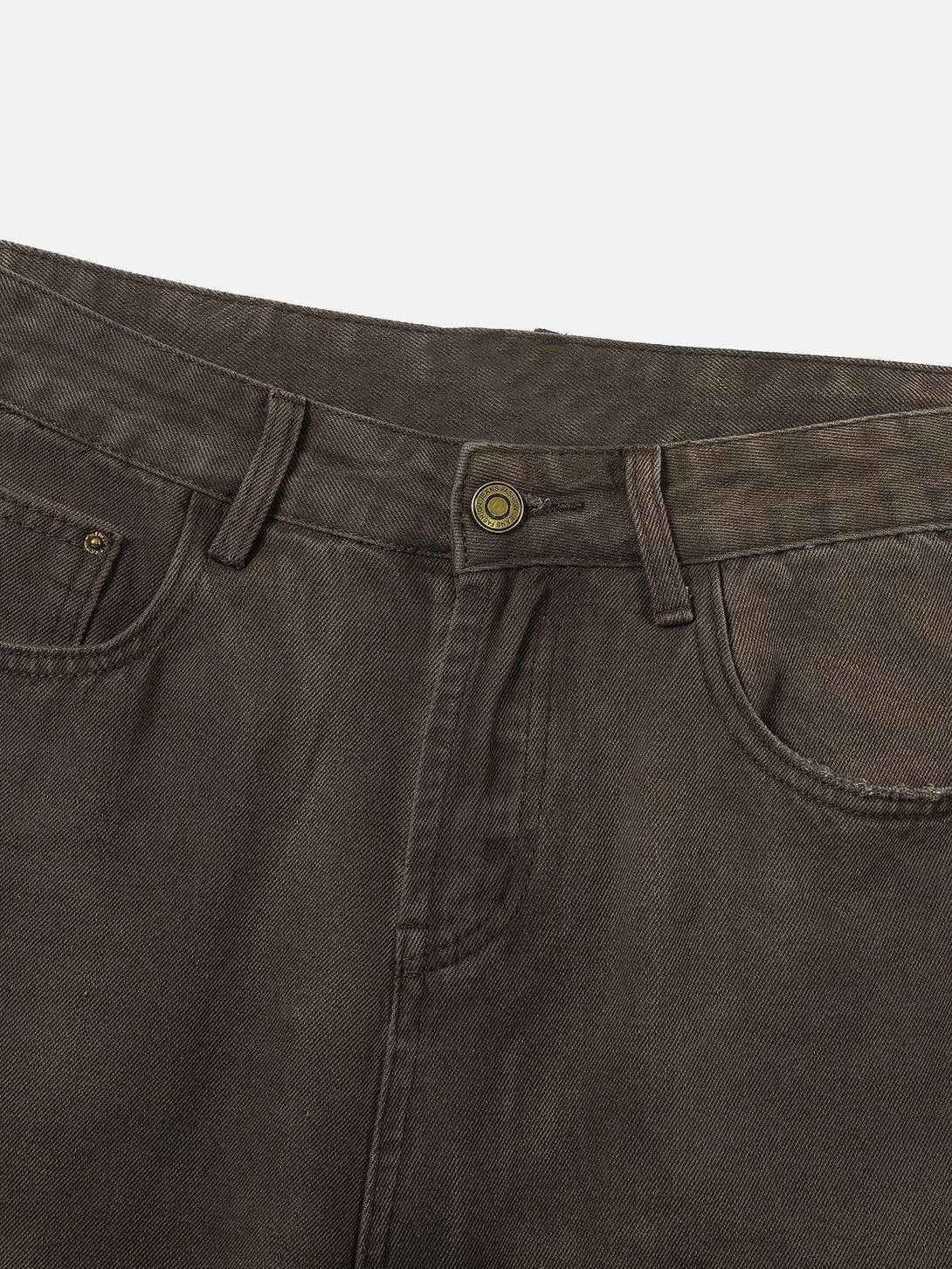 Detailed fabric and stitching of TALISHKO distressed washed jeans, showcasing rugged texture.