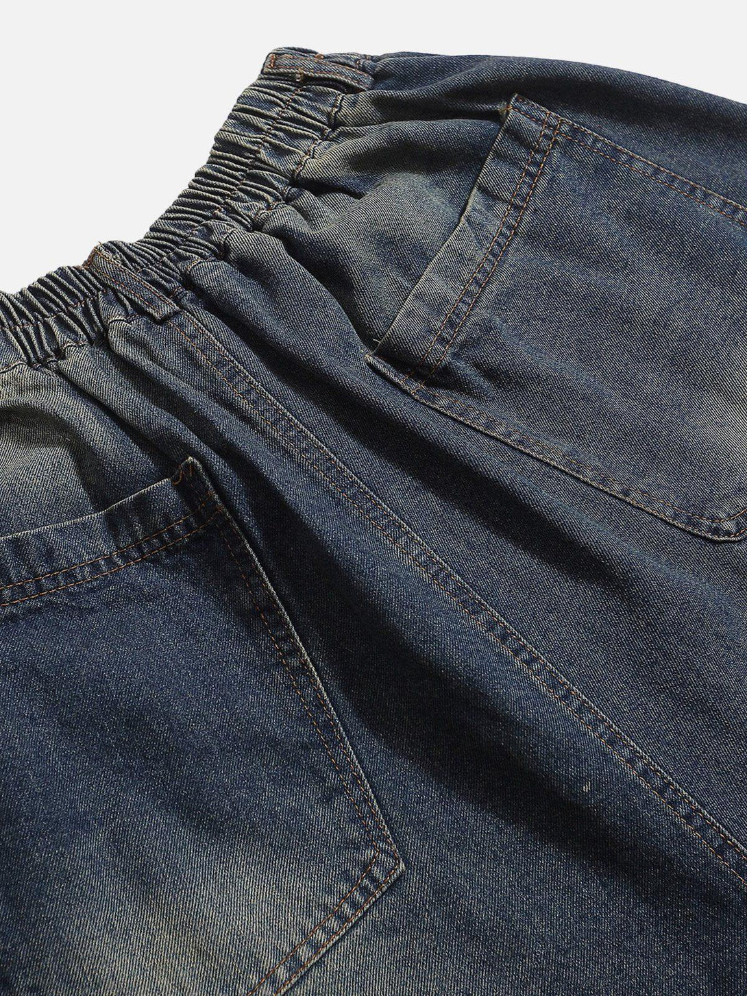Elastic waistband and pocket details of distressed washed jorts by TALISHKO, ideal for casual wear.