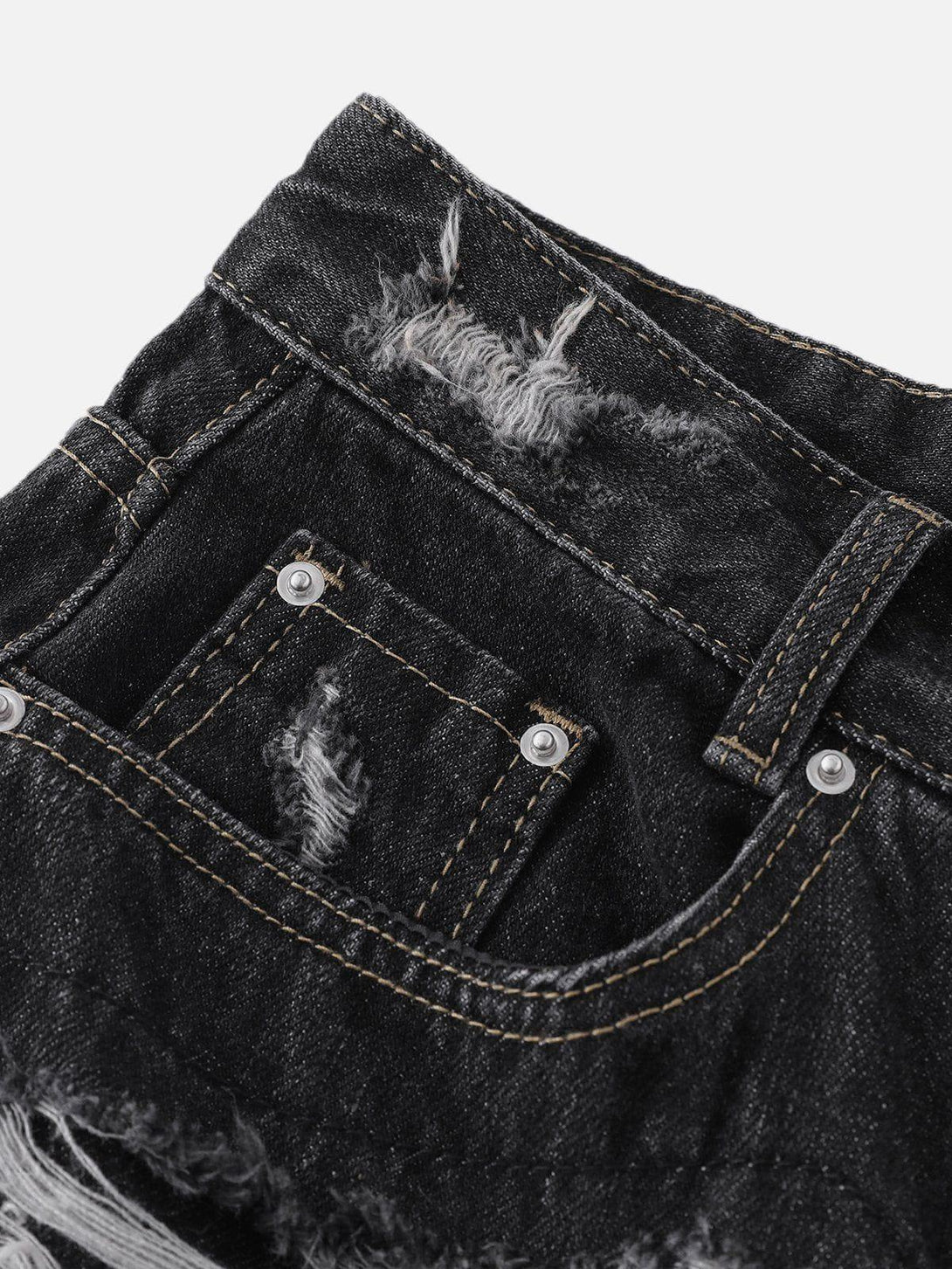 A close-up of TALISHKO's distressed black jorts, highlighting rugged stitching and texture.