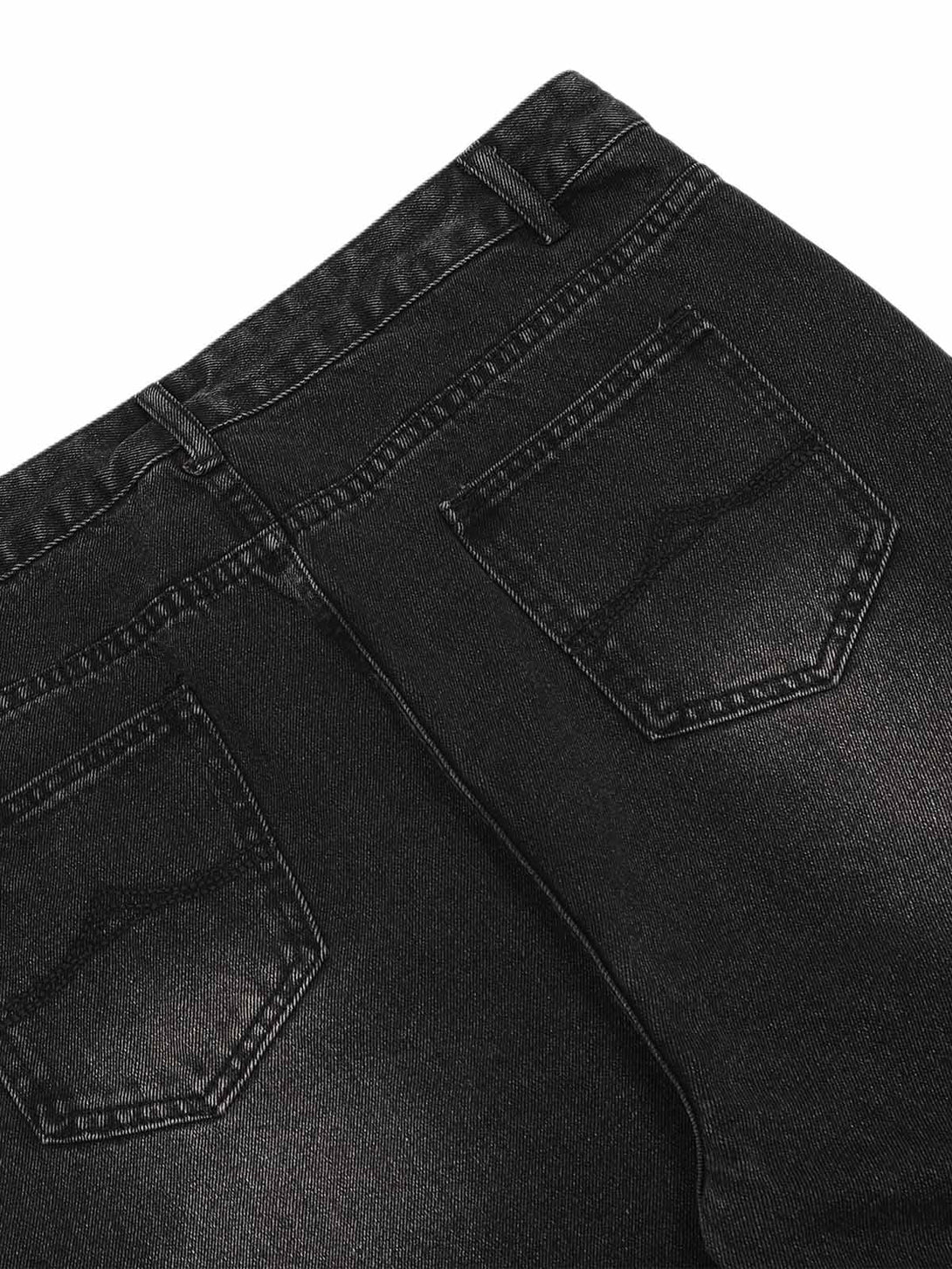 Close-up of TALISHKO cargo jeans' back pockets, showcasing the distressed wash and detailing.