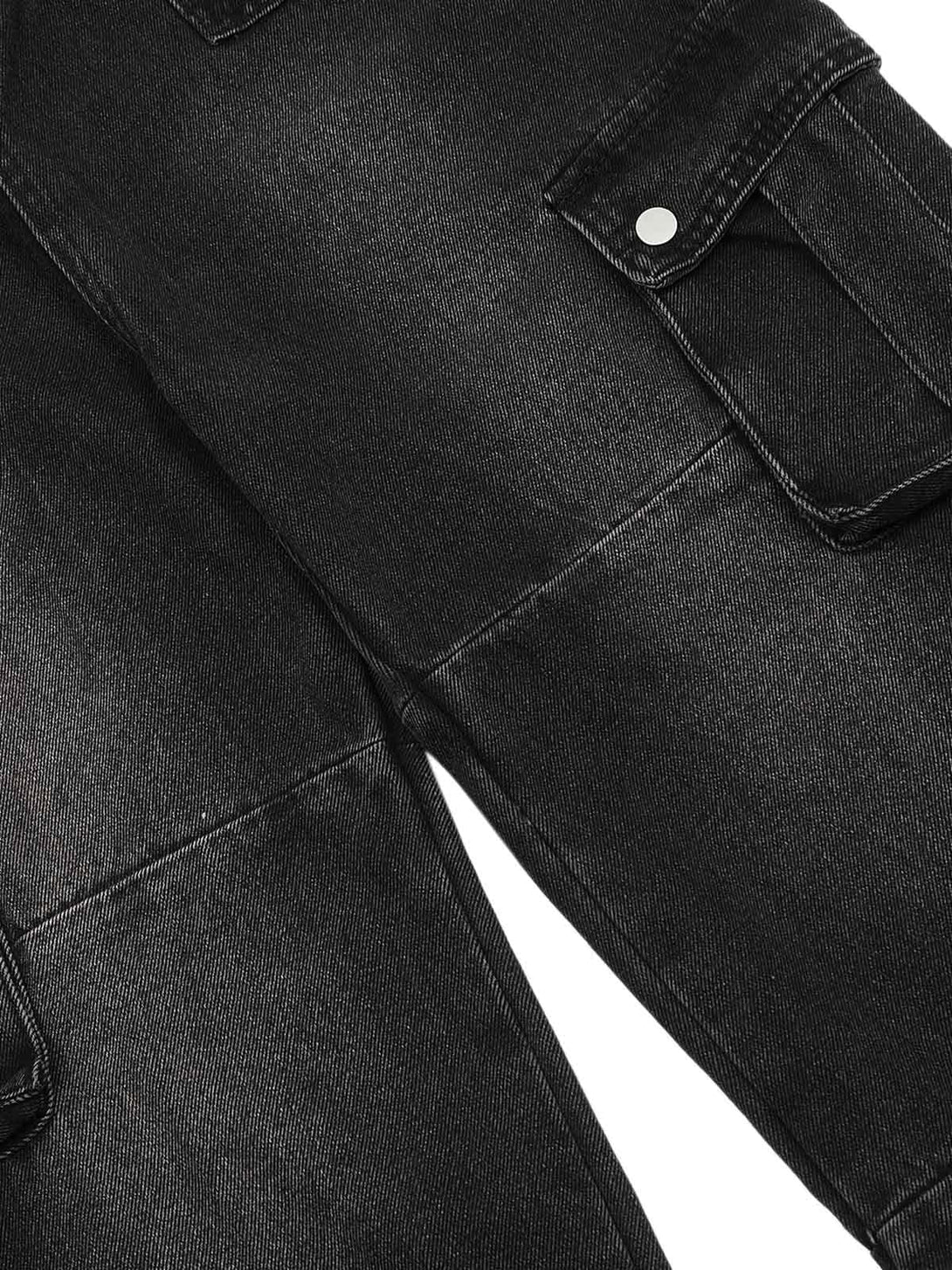 A detailed view of TALISHKO cargo jeans, highlighting the distressed wash and utility pockets.