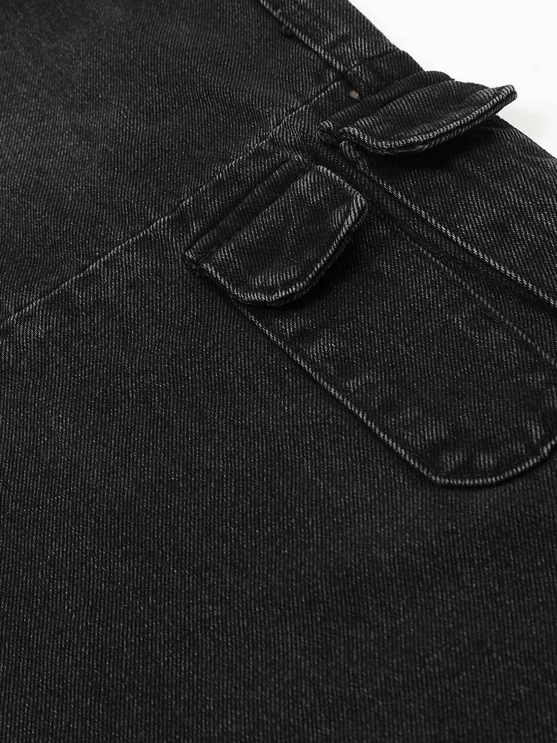 Detailed fabric and stitching of TALISHKO cargo jeans, highlighting the multi-pocket design.