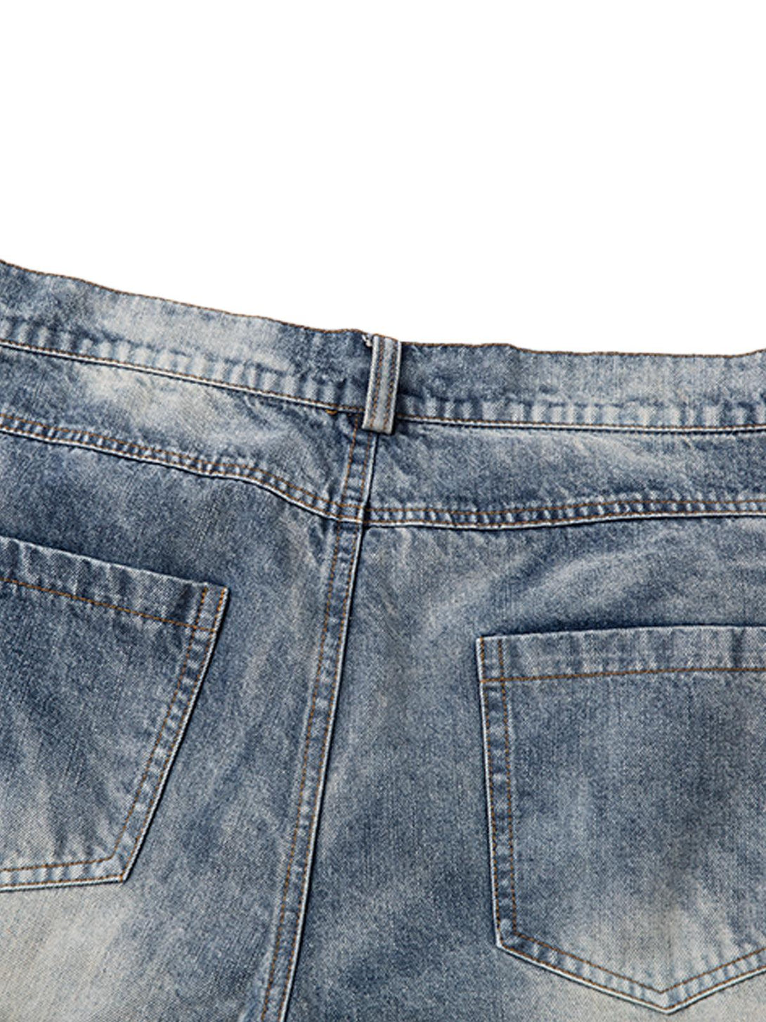 A detailed look at the back pockets of TALISHKO's distressed washed pleated jeans.