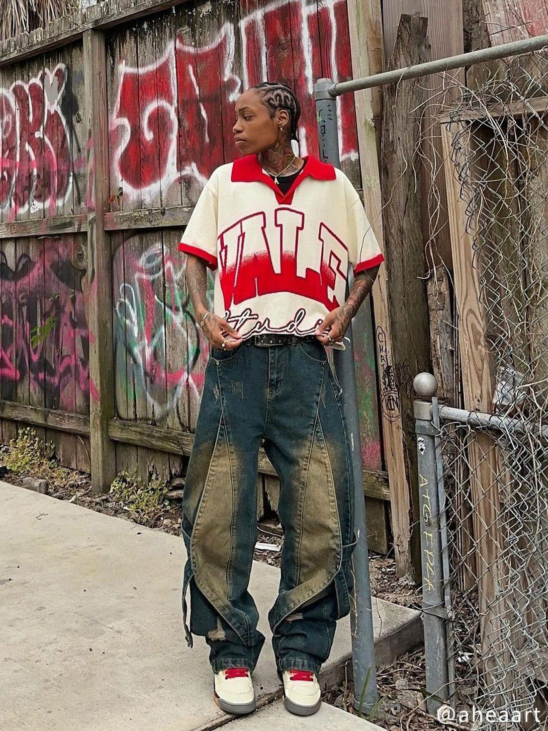 Model wearing distressed washed stitching jeans paired with a bold graphic shirt by TALISHKO.